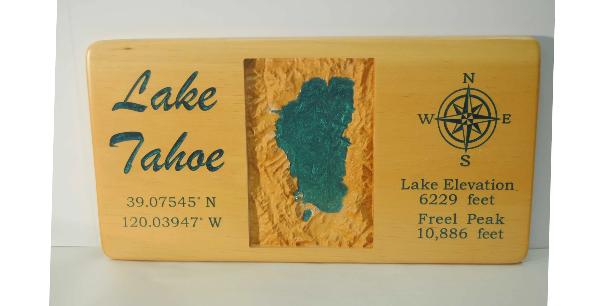 CNC 3D carved topographical map ofLake Tahoe with words and ocean filled with colored epoxy. 11 x 23 inches