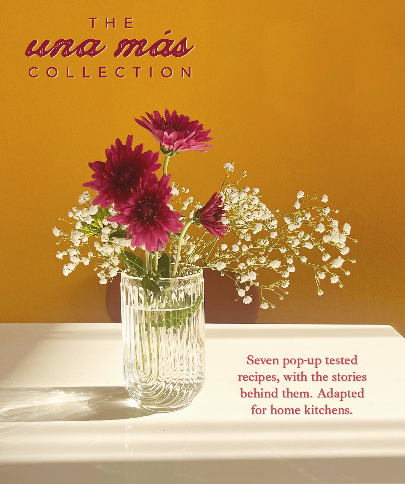 A glass vase with pink and purple flowers and white baby's breath on a white surface in front of a yellow background with the text "The una mai collection" and a description about pop-up tested recipes.