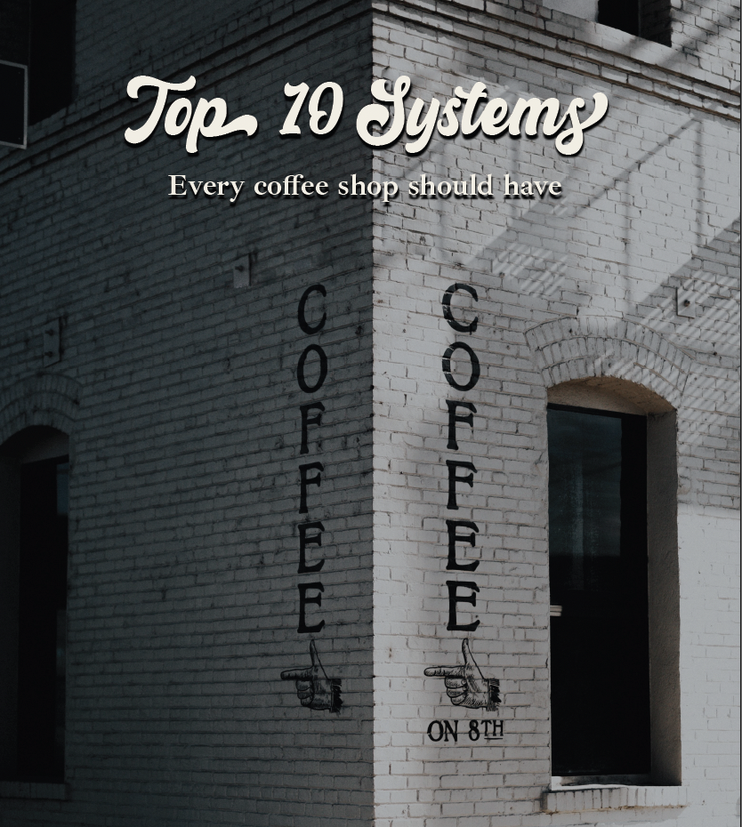 A white brick building with a sign that reads 'Top 10 Systems' and 'Every coffee shop should have coffee' in stylized fonts. The wall features two vertical black signs spelling out 'COFFEE' with pointing hand illustrations at the bottom, and the phrase 'ON 8TH' below.</imageAltText>