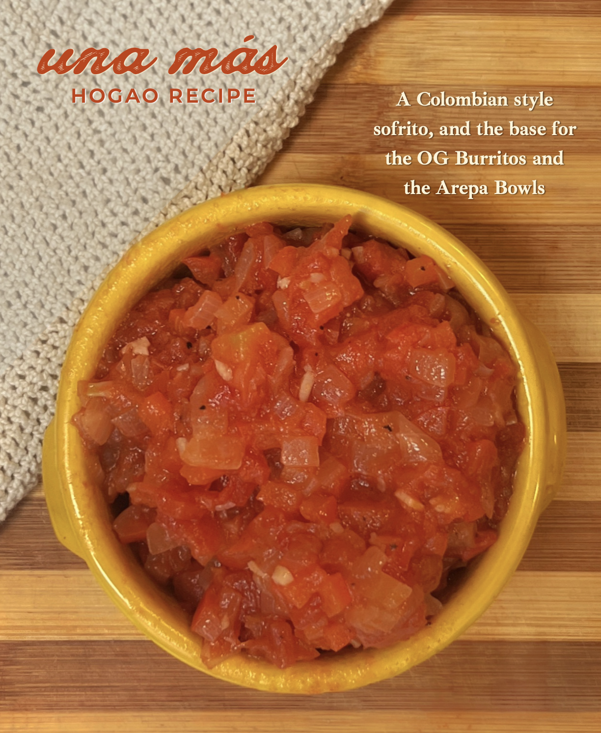 A yellow bowl filled with Colombian-style tomato and onion salsa on a wooden surface, with a beige cloth and descriptive text about the dish in the background.