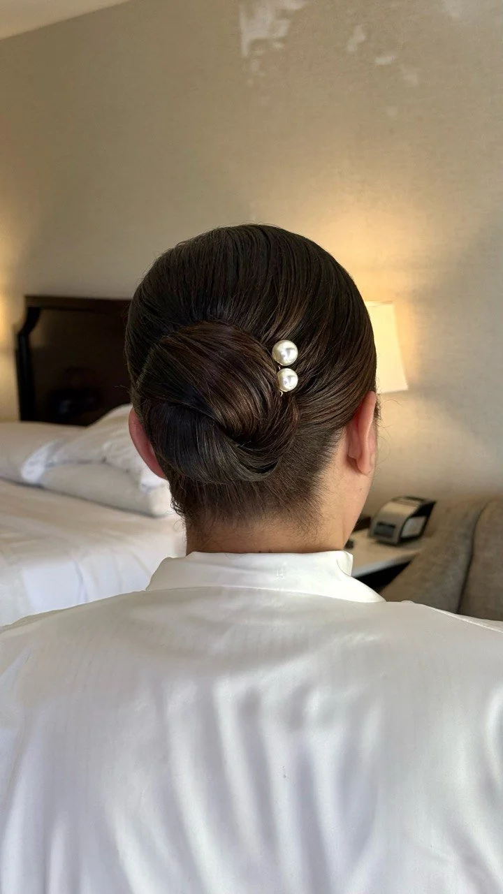 Low bridal bun with pearl pins — wedding updo by Yanita Esqao, bridal hair Los Angeles