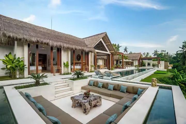 Luxury tropical resort with thatched villas and infinity pool at Bali yoga and pilates retreat Indonesia stunning wellness sanctuary