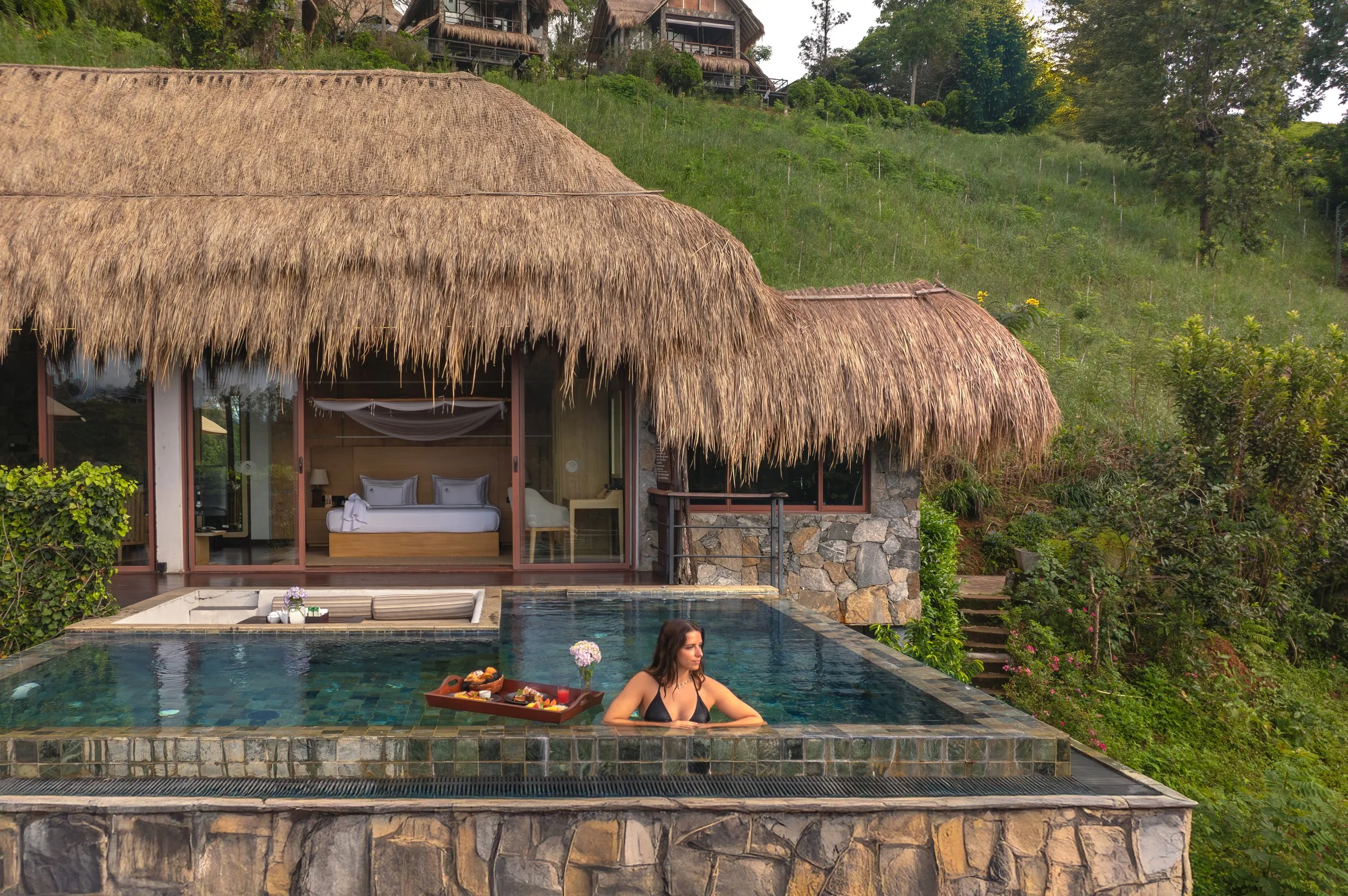 Woman relaxing in infinity pool luxury Sri Lanka yoga retreat accommodation