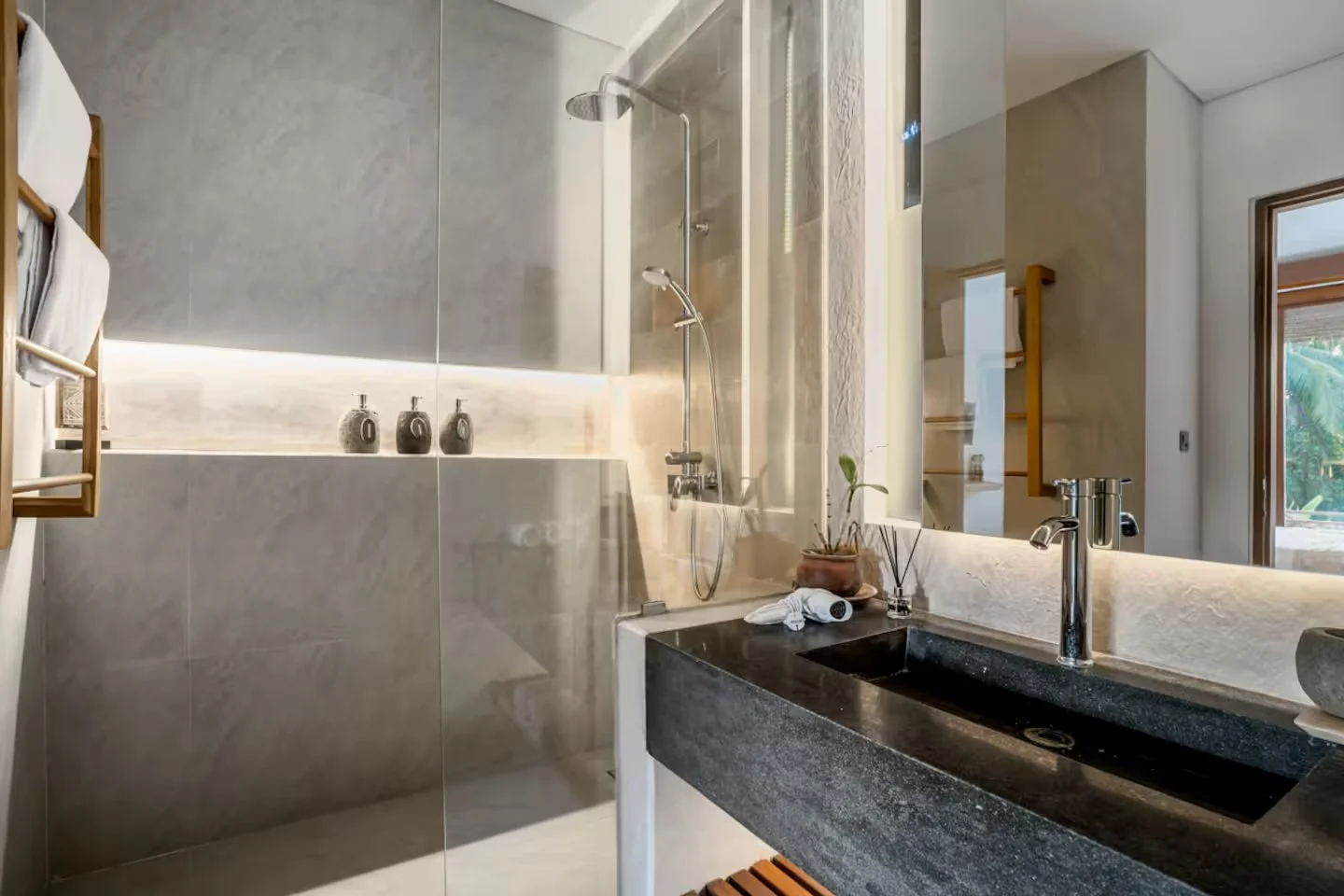 Modern luxury bathroom at Bali yoga and pilates retreat Indonesia with stone sink natural materials and garden views