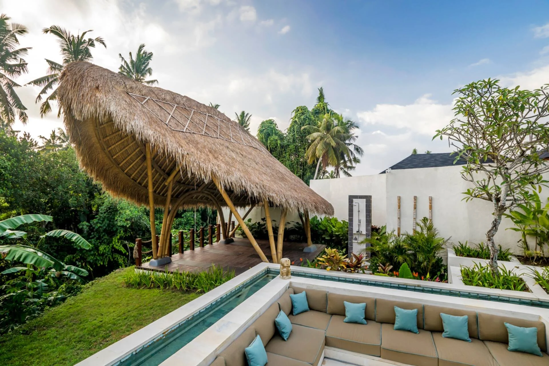 Luxury outdoor lounge with thatched hut and private pool at Bali yoga and pilates retreat Indonesia tropical relaxation space