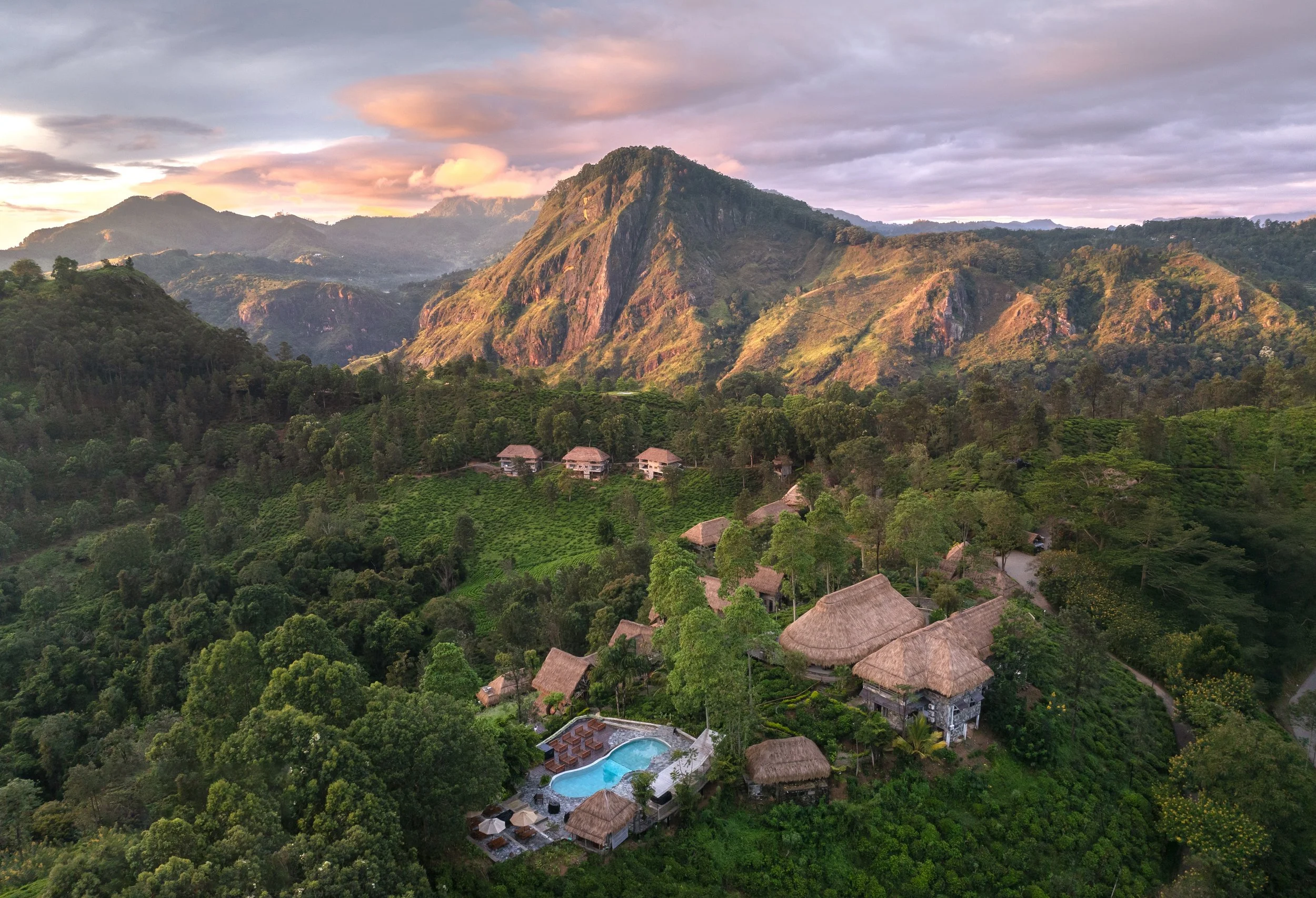 Luxury yoga and pilates retreat in Bali Indonesia surrounded by lush green mountains thatched roof villas and tropical swimming pool