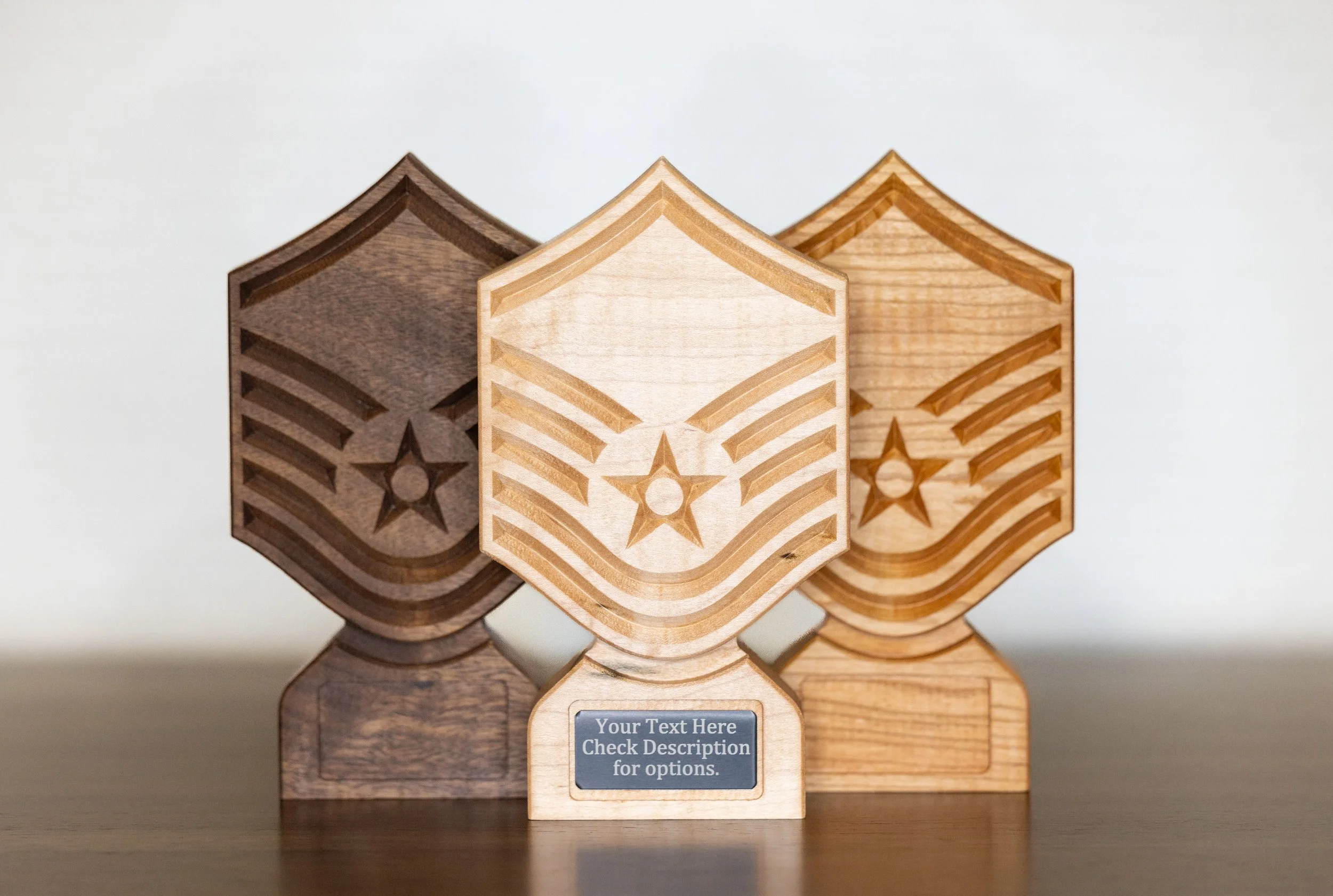 Three wooden hexagonal blocks with engraved star and stripe patterns, arranged side by side on a flat surface, with a placeholder text label below.
