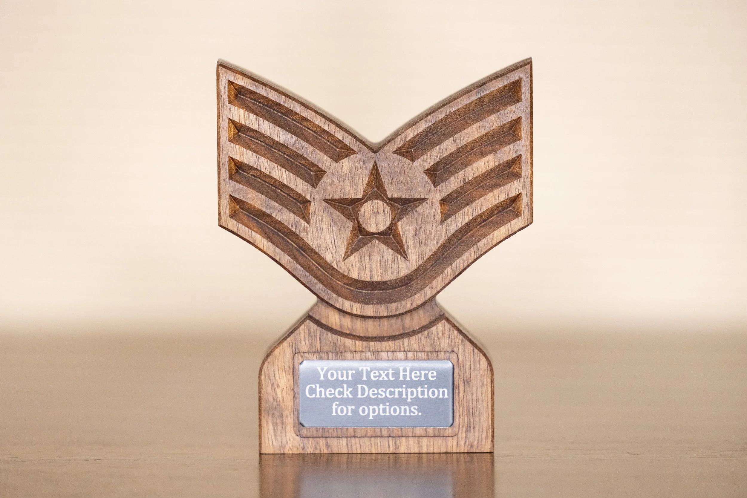 Wooden trophy with a star and chevron design, and a placeholder for customizable text on a gray plaque.