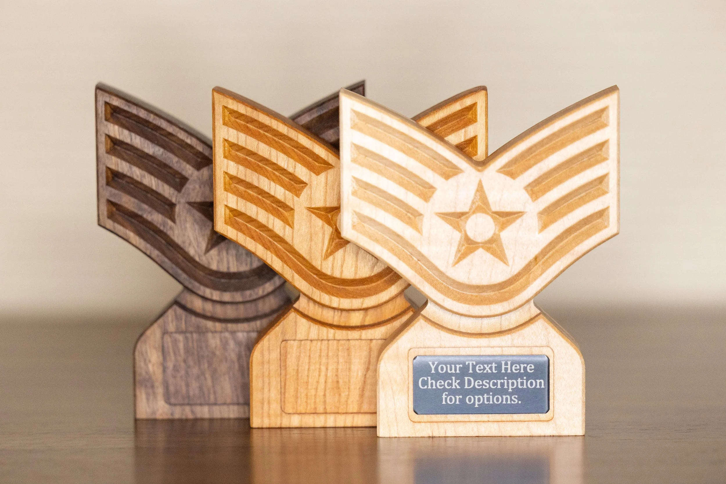 Close-up of wooden trophy or award with a star and stripes design, and a customizable plaque area at the bottom for text.