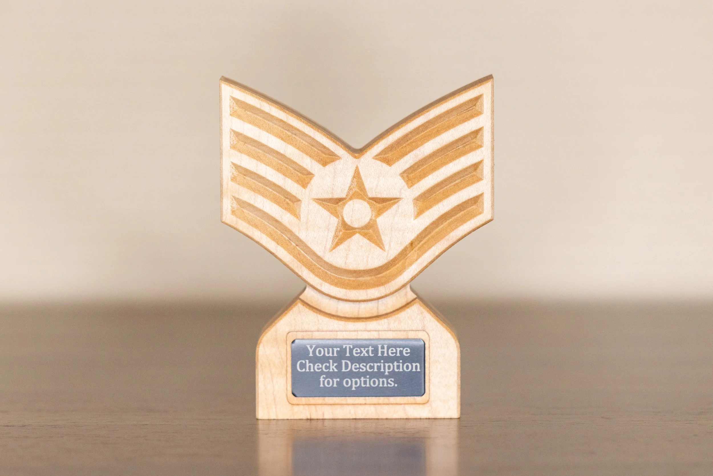 A wooden trophy with a star and stripes engraving, and a blue plaque that says 'Your Text Here Check Description for options.'