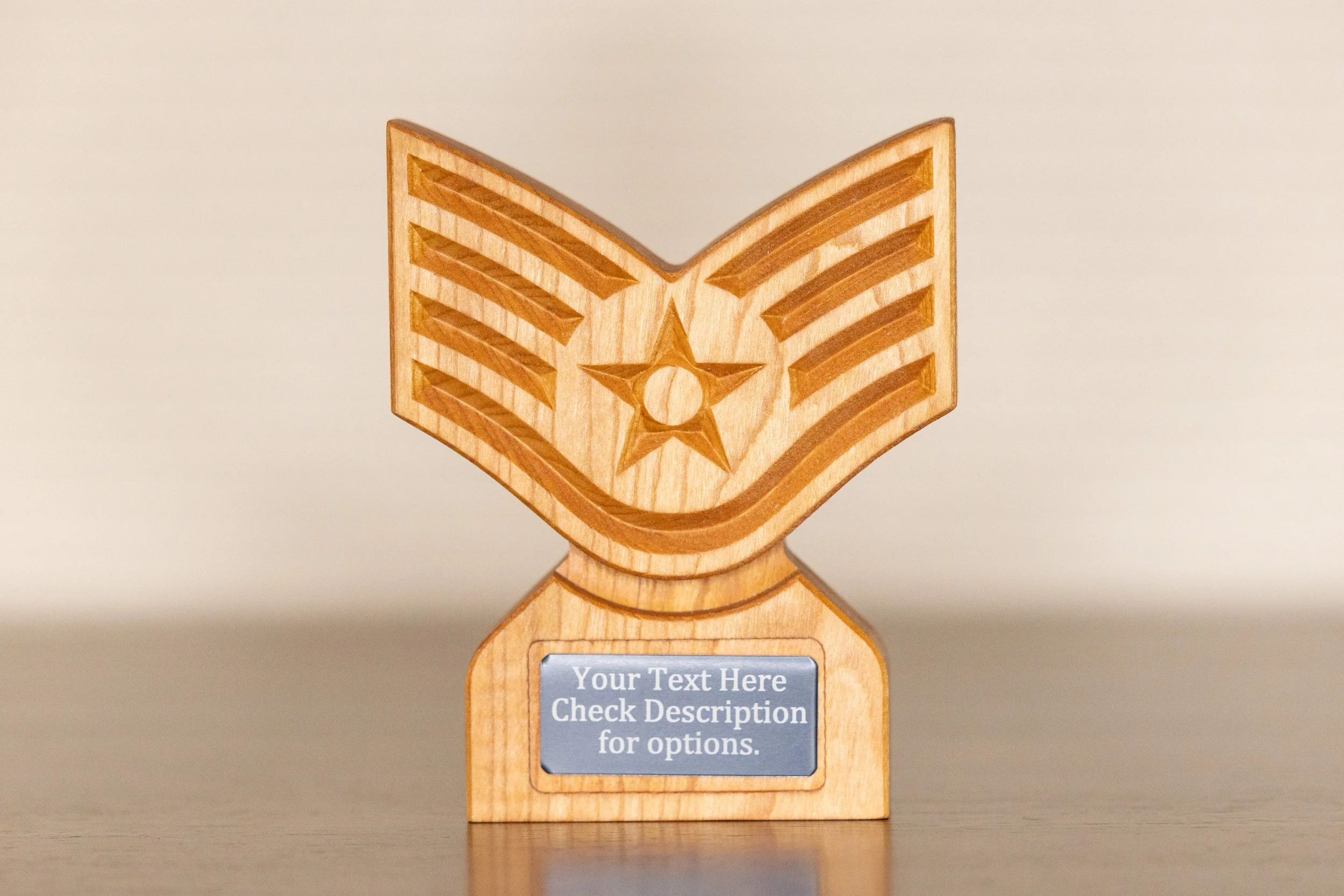 Wooden medal with a gold star and striped ribbon design, mounted on a wooden base with a customizable metal plate.