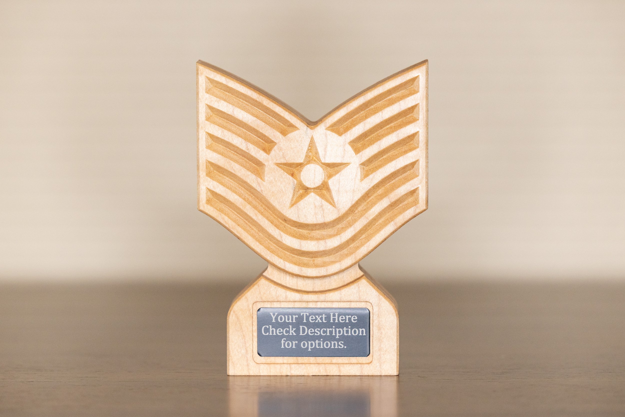 A wooden award trophy designed in a star shape with a star and stripes pattern engraved on the front. It has a black plaque at the base with placeholder text for customization.