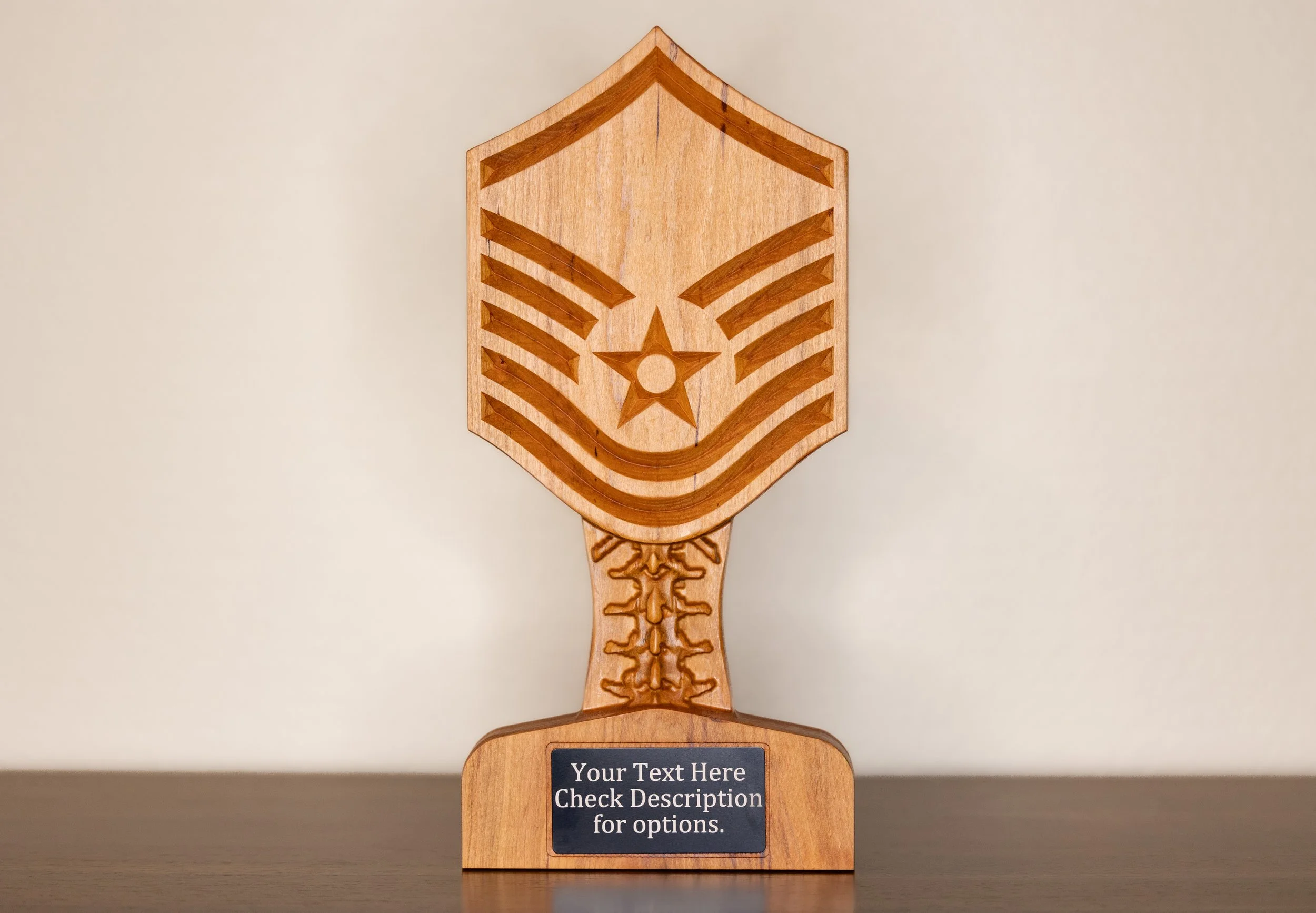 A wooden trophy with a star and chevron design, and a blank plaque space with a placeholder for custom text.