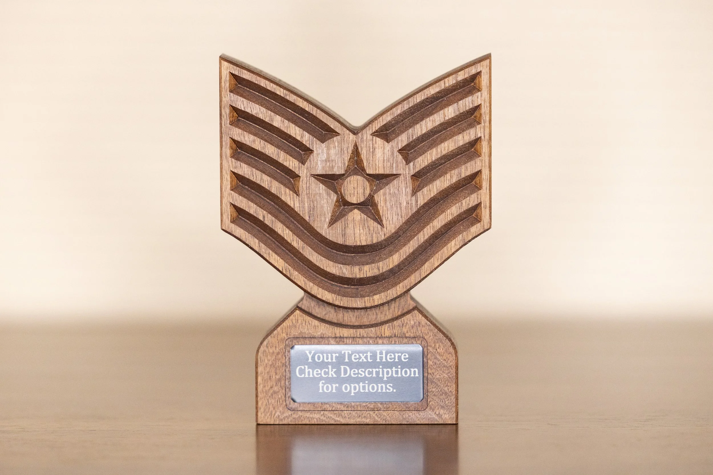 A wooden trophy with a star and chevron design on the front, featuring a customizable nameplate that reads, 'Your Text Here. Check Description for options.'