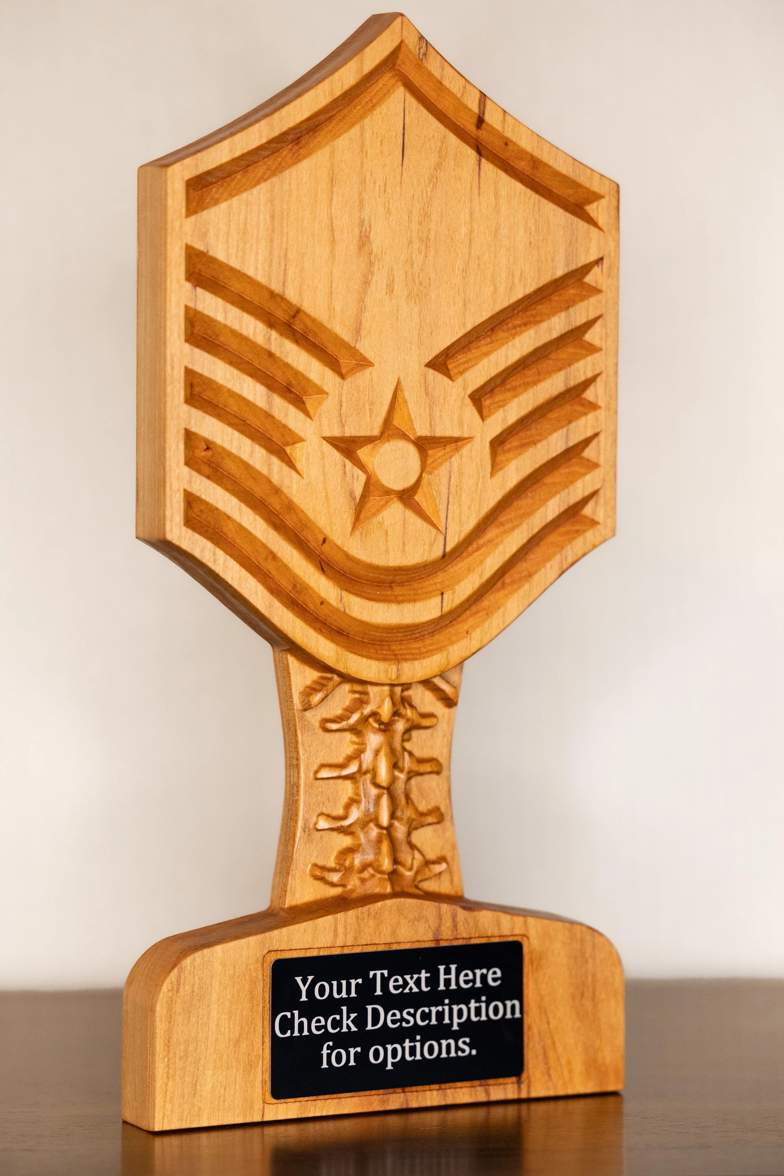 Wooden trophy or award with a star and chevron designs at the top, and a black plaque with white text that says, 'Your Text Here Check Description for options.'