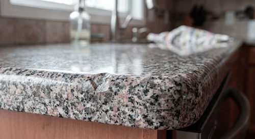 Chipped granite countertop edge before repair