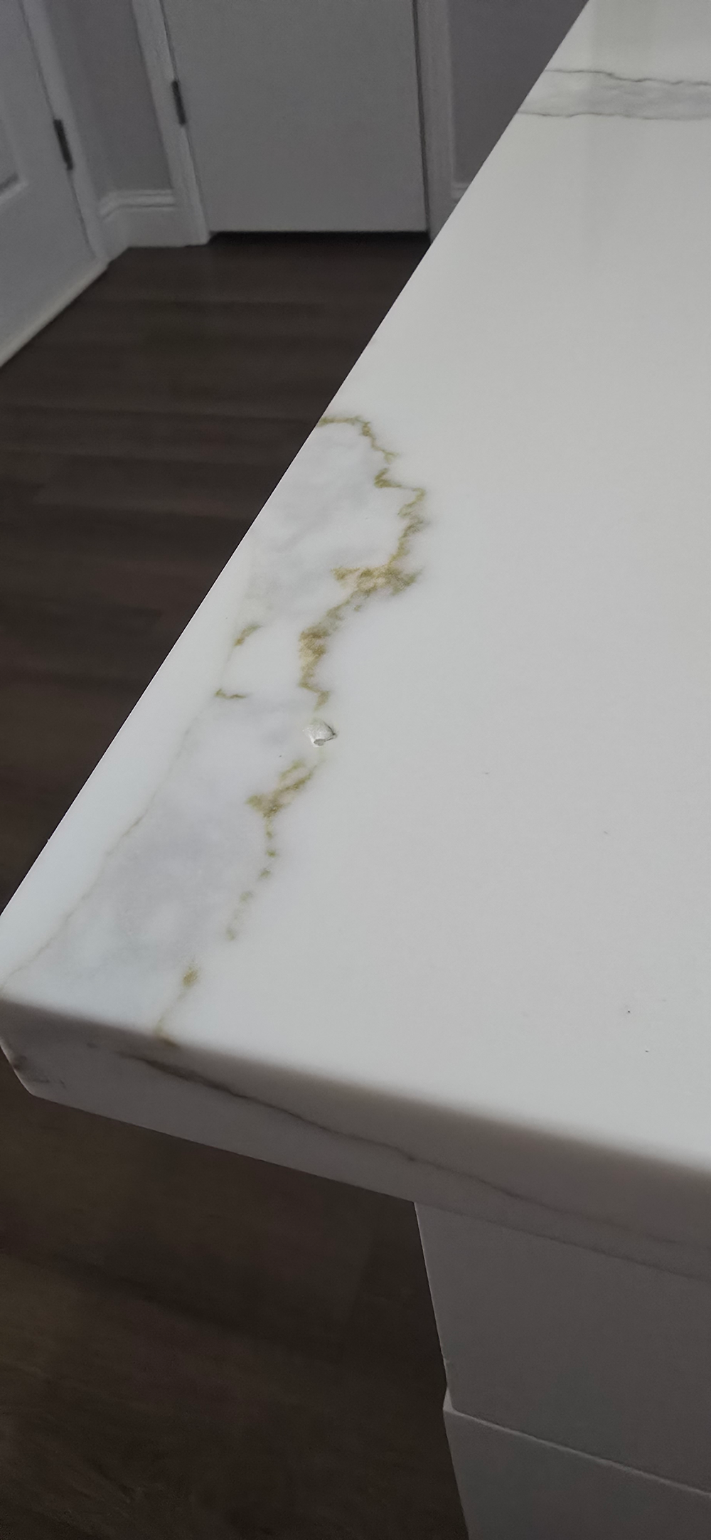 Chipped quartz countertop before repair