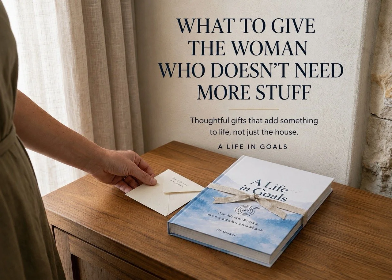 A Life in Goals hardcover journal beside a handwritten gift note, illustrating a thoughtful gift for a woman who does not need more stuff.