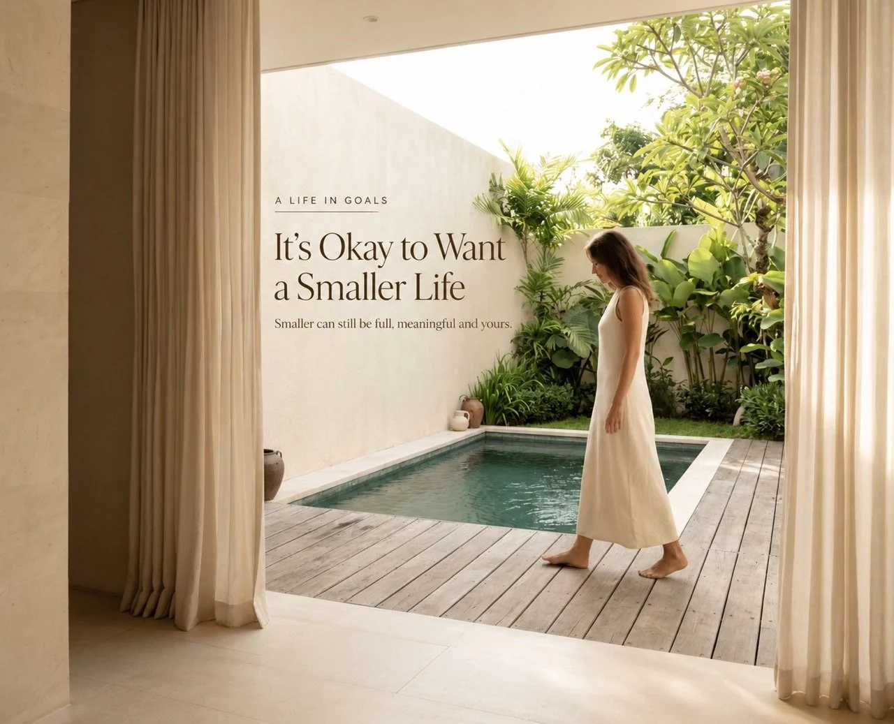 Woman walking beside a quiet courtyard pool with the words It’s Okay to Want a Smaller Life, reflecting a slower and more intentional way of living.