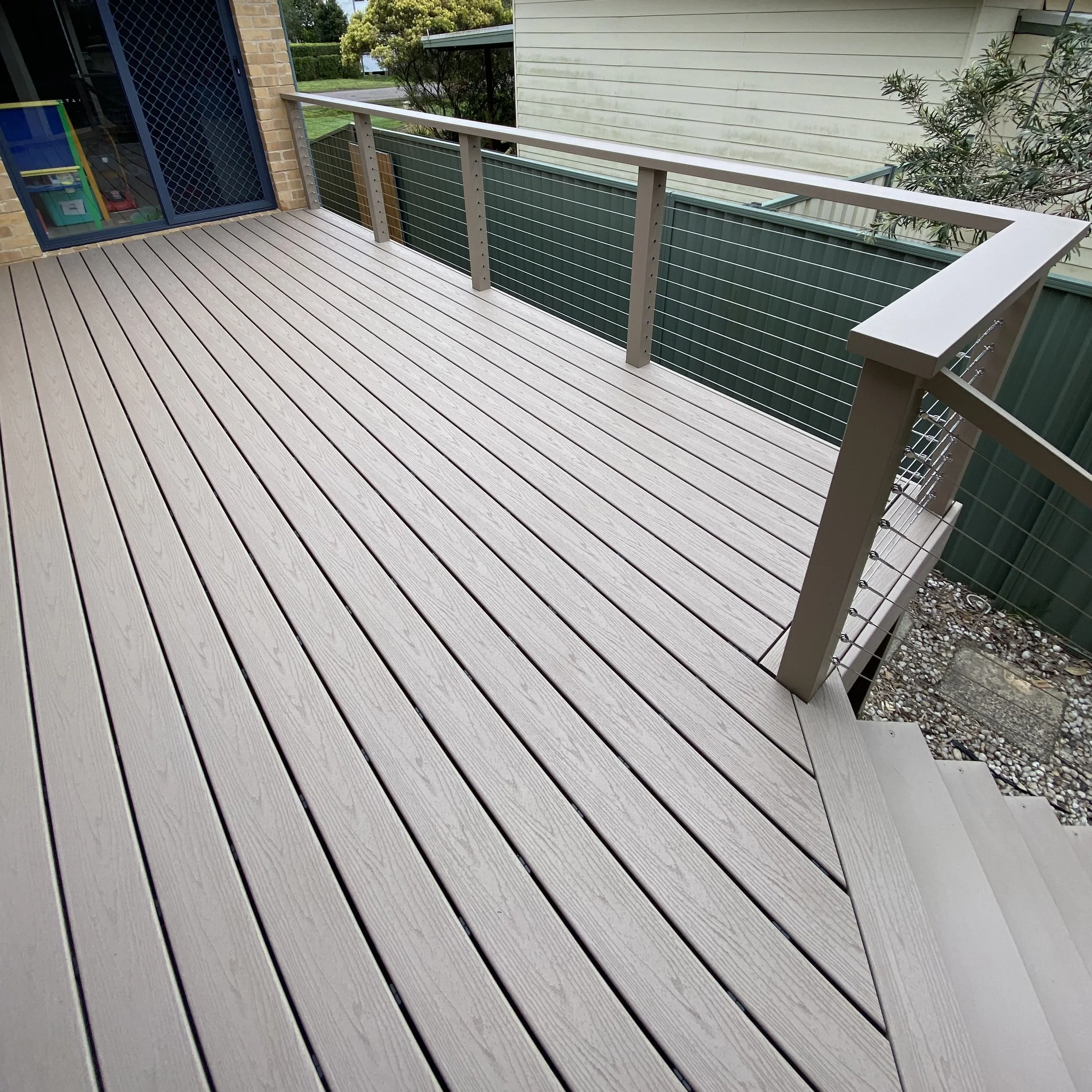 Trex deck in Rope Swing with modern metal balustrade and elevated views completed by Platinum Decks to provide a sleek, luxury outdoor entertaining platform