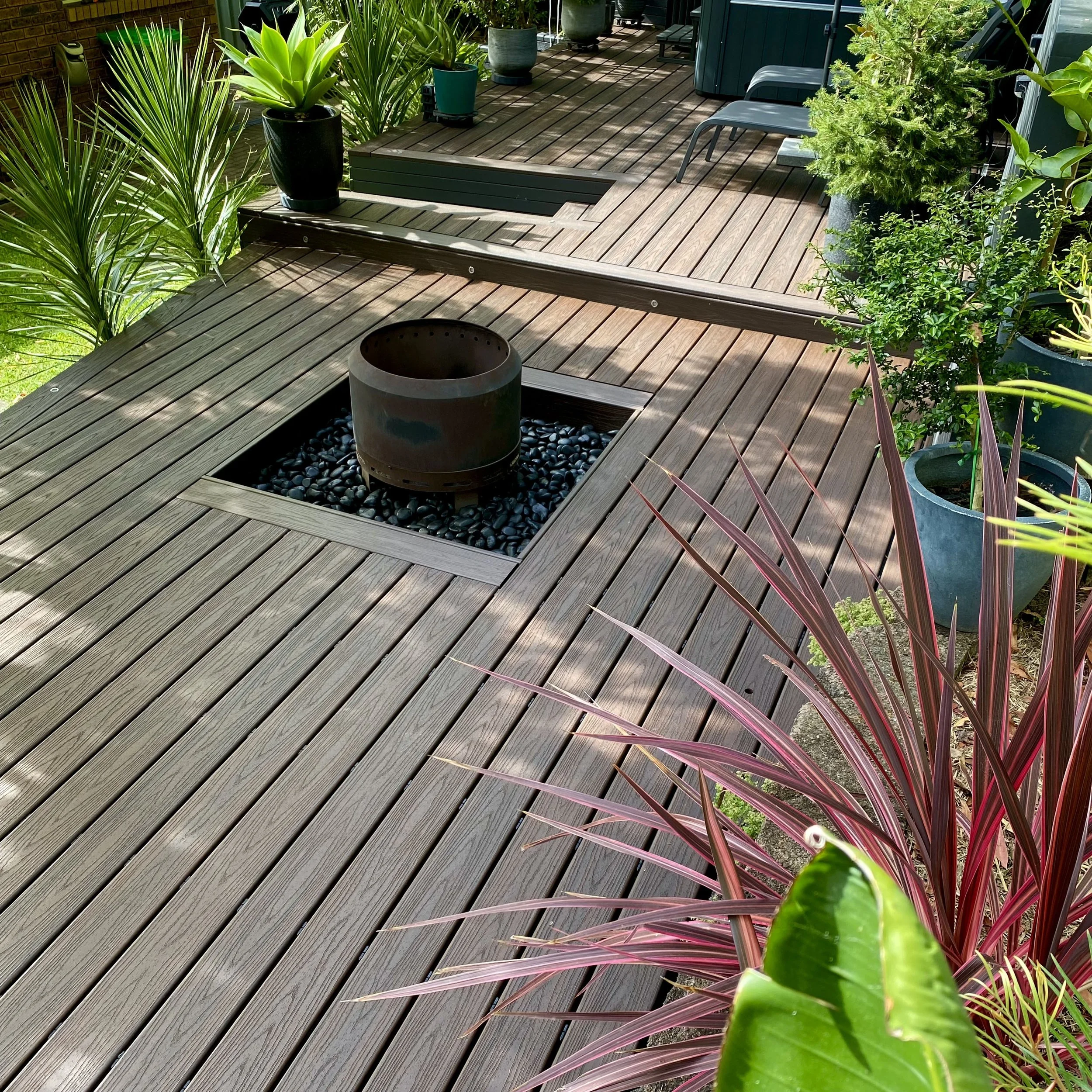 Custom designed Firepit and composite deck for laid back evenings with friends. Designed and built by Platinum Decks.