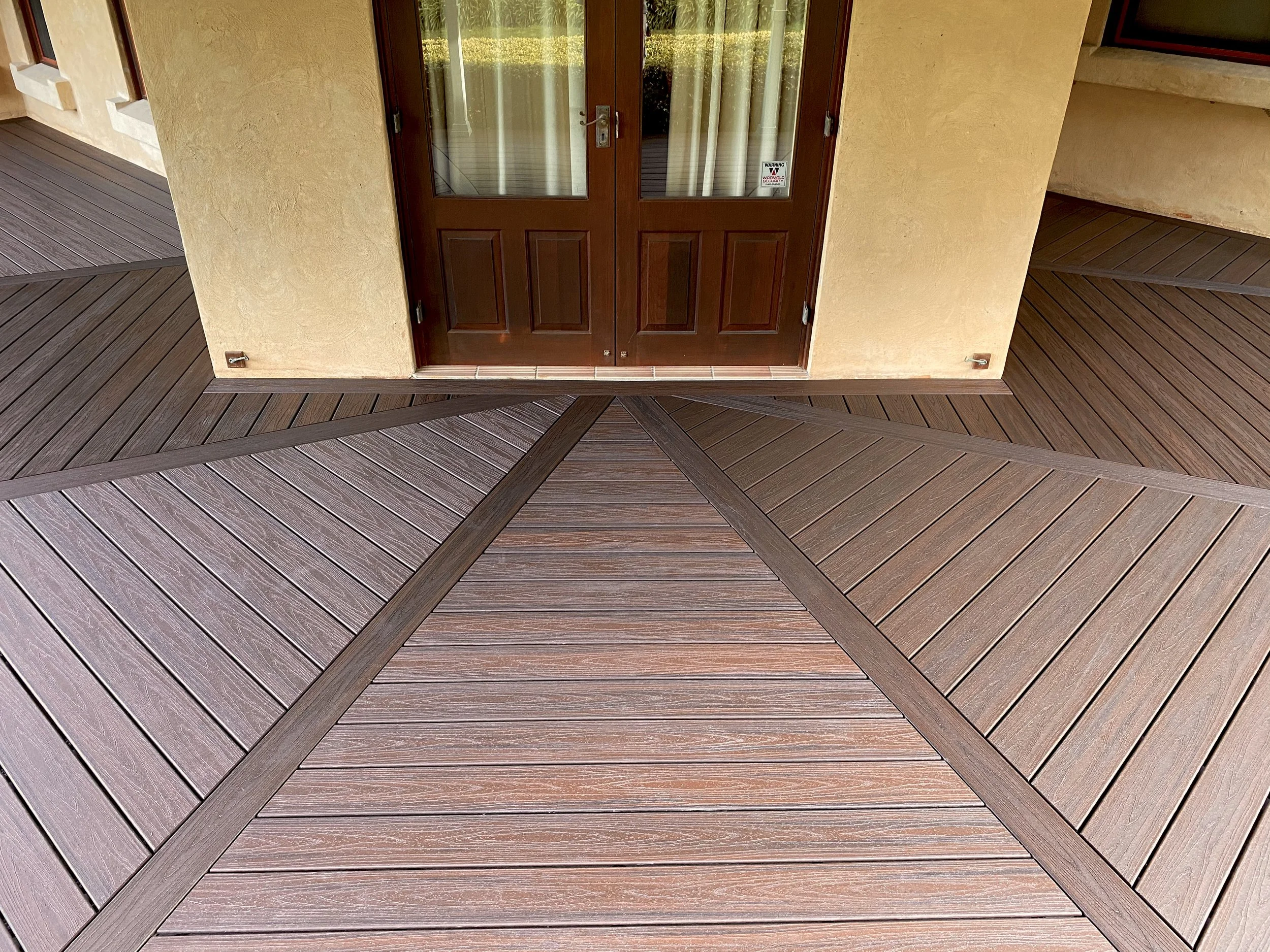 Trex deck in Lava Rock with premium double doors finished by Platinum Decks to elevate the transition between indoor and outdoor living