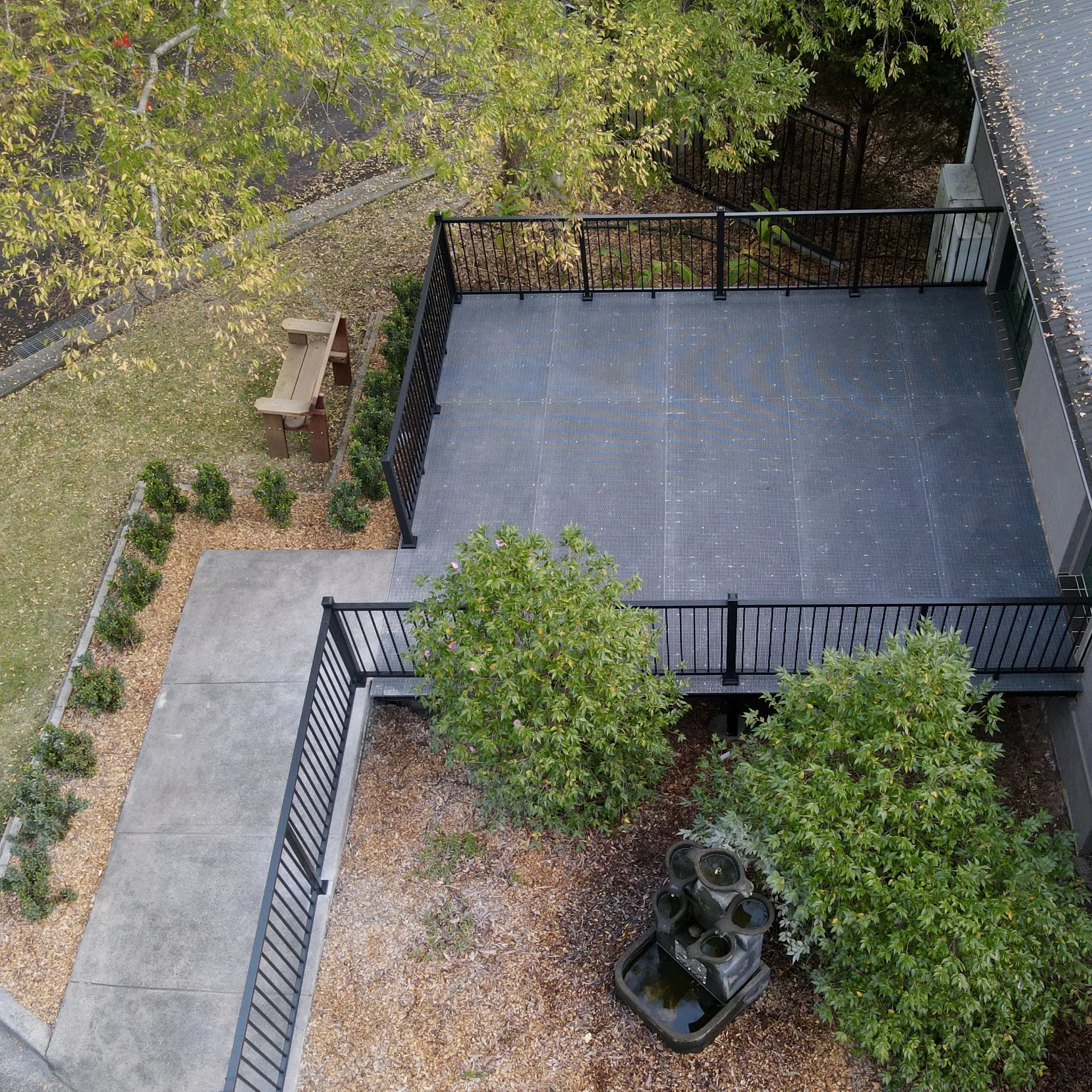 Commercial FRP deck with aluminium railing completed by Platinum Decks with lush landscaping