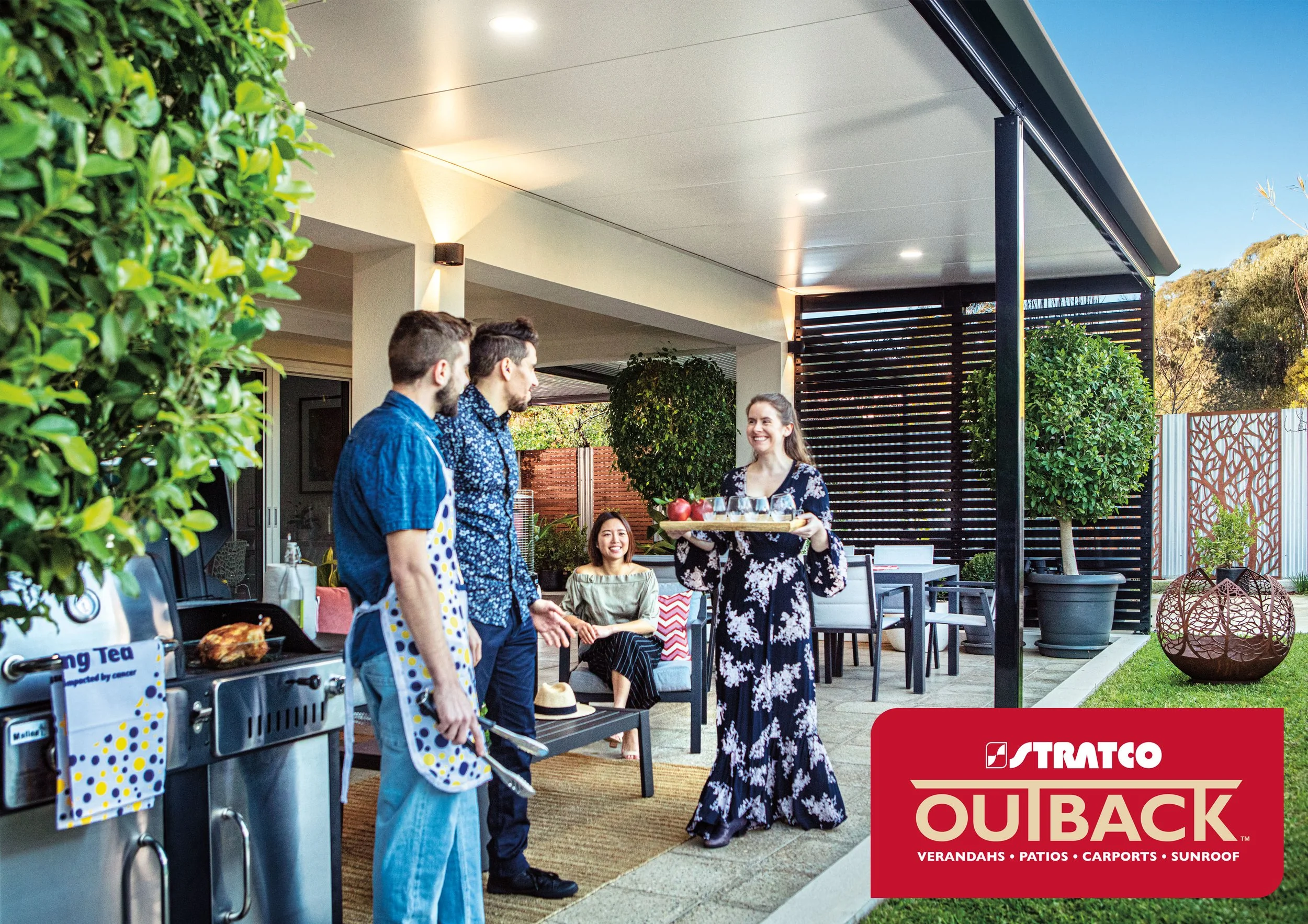 People gathering on a patio outside a building during daytime. Platinum Decks authorised Stratco Outback Dealer.