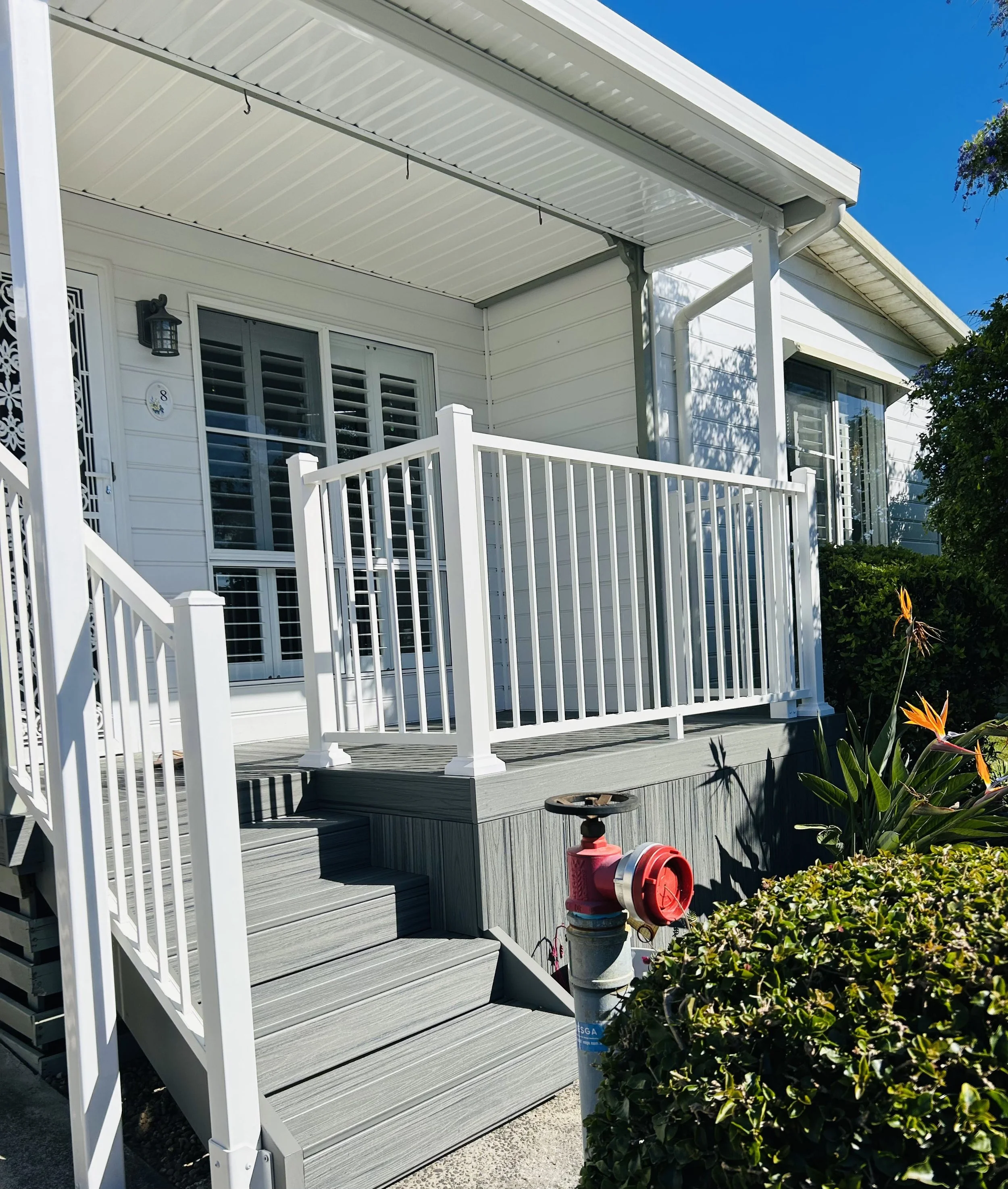 Bright composite alfresco porch area with clean white balustrade designed for relaxed, high‑end living, built by Platinum Decks using materials ideal for Central Coast humidity and sea air