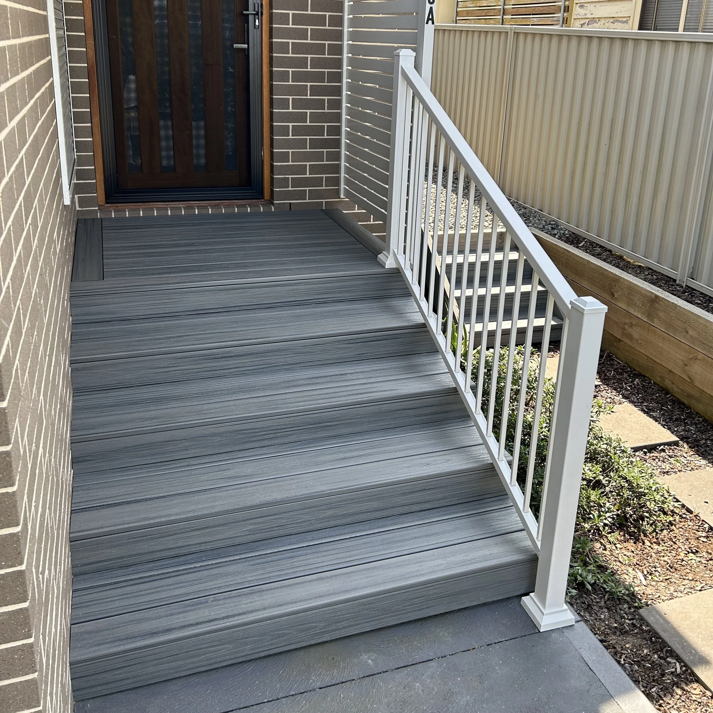 Composite porch with white balustrades created by Platinum Decks for homeowners wanting low‑upkeep outdoor spaces suited to Central Coast conditions
