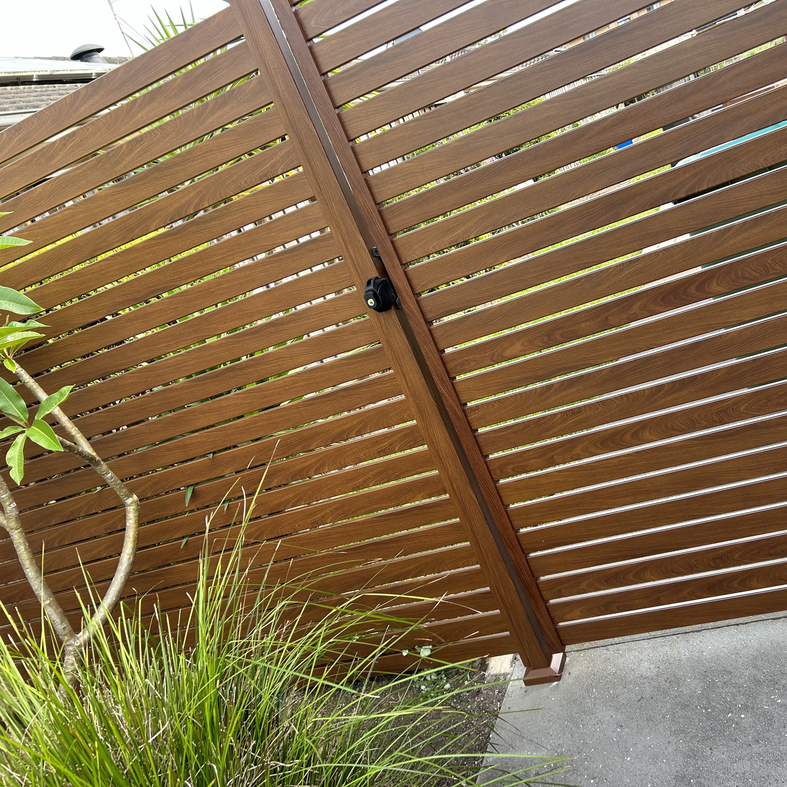 Designer privacy screen and fence with warm timber tones installed by Platinum Decks to provide elegant shade and seclusion in premium alfresco spaces