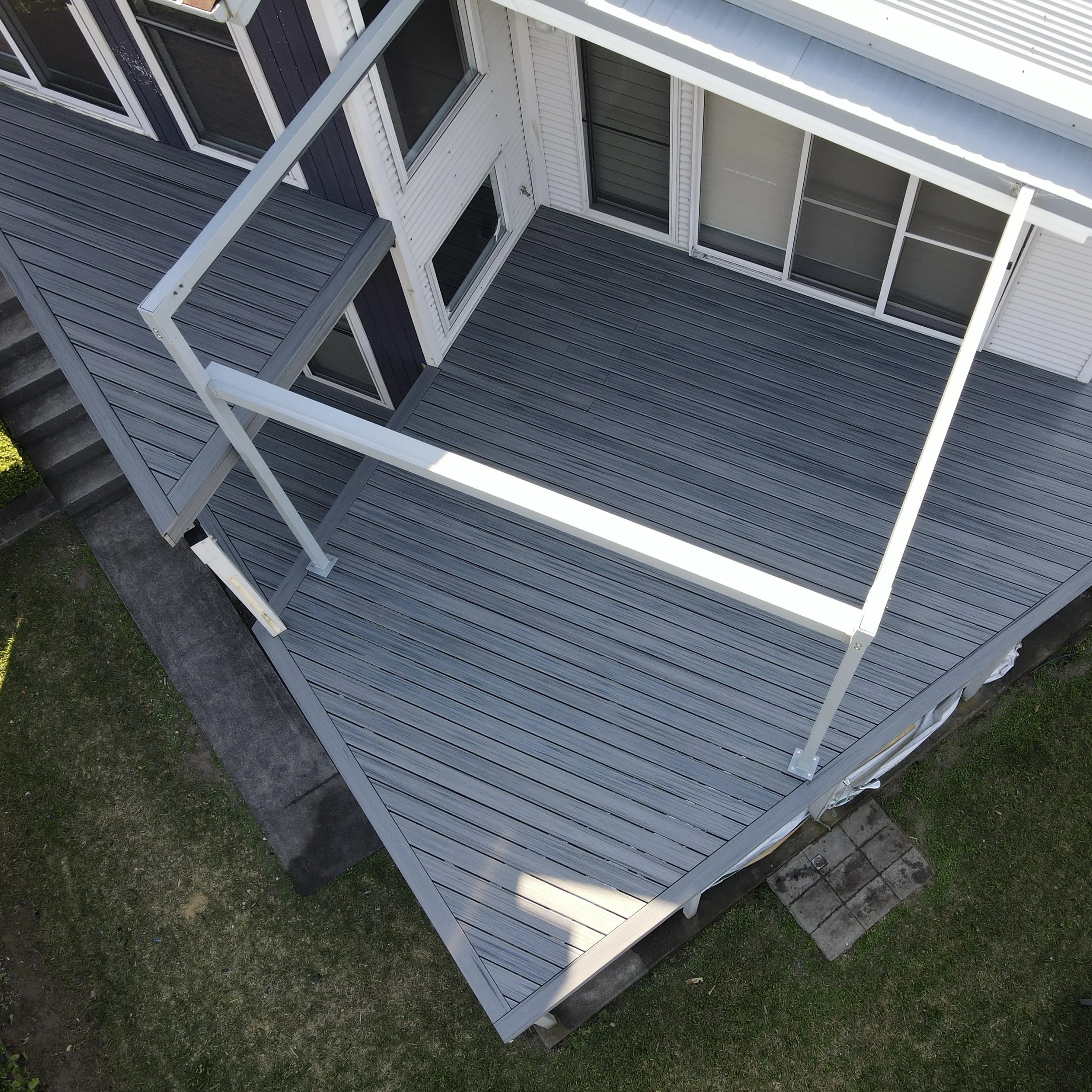 Modern apartment Trex deck in Island Mist with premium outdoor layout designed by Platinum Decks to elevate compact spaces with a high‑end composite finish