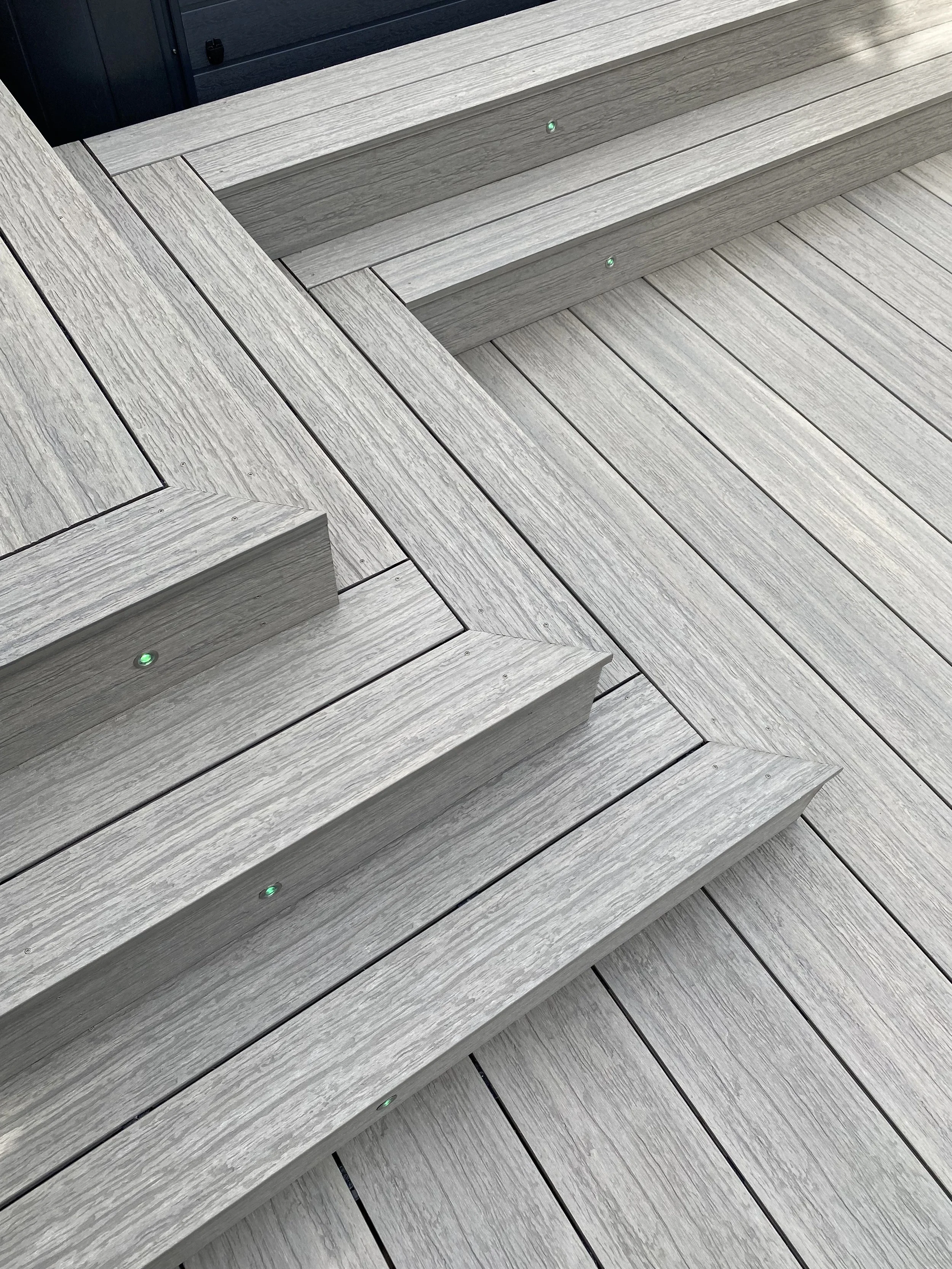 Composite decking laid in a premium diagonal pattern crafted by Platinum Decks to elevate high‑end patio design with a refined, custom finish
