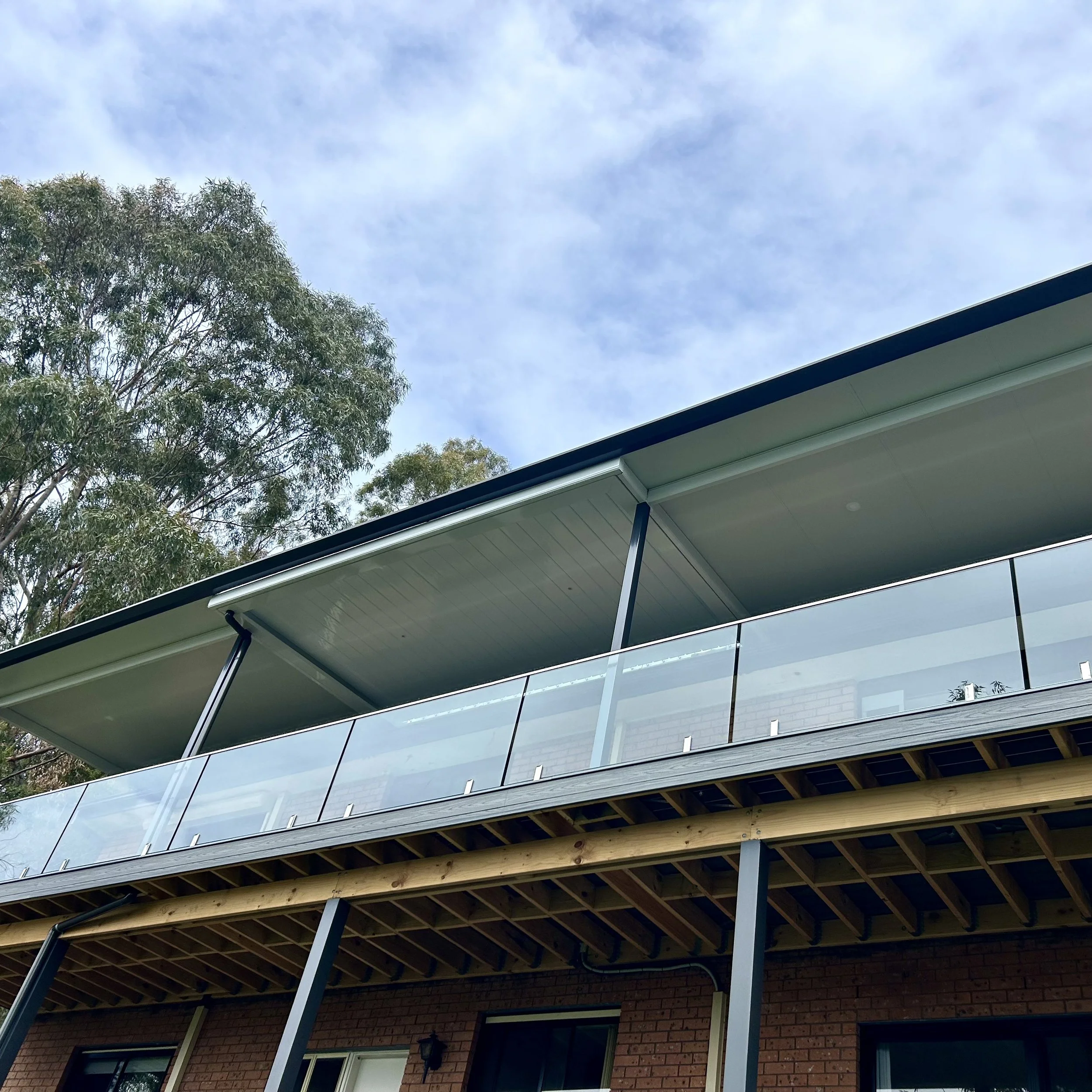 Sophisticated roofline and guttering enhancing a contemporary outdoor area completed by Platinum Decks to create a polished, high‑end space built for Central Coast weather