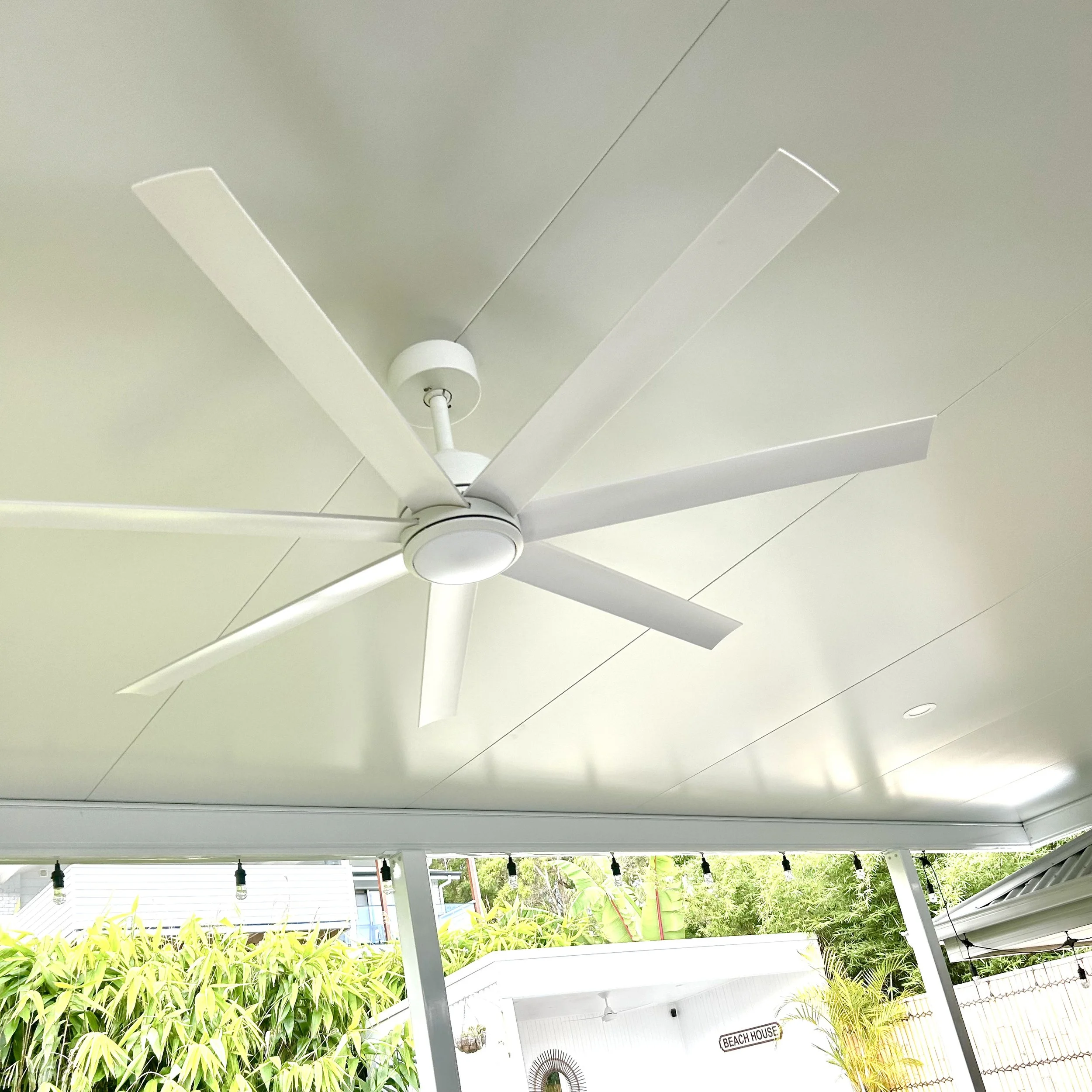 Stratco Outback Cooldek patio with ceiling fan overlooking lush garden crafted by Platinum Decks to deliver a cool, luxury alfresco living zone