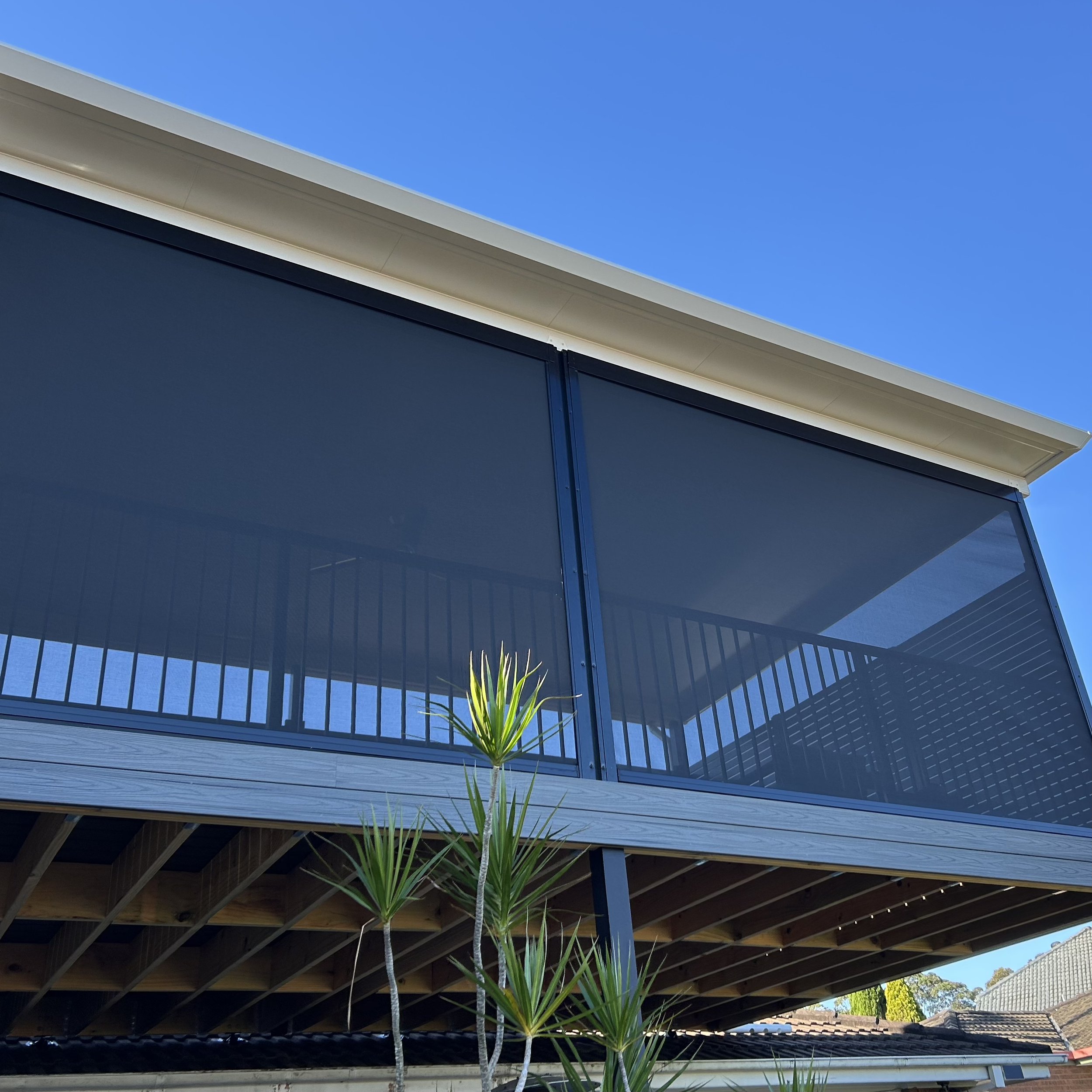 Upper level composite deck with custom screening panels and pergola cover, providing shade, privacy and all weather use installed by Platinum Decks - Patios and outdoor living