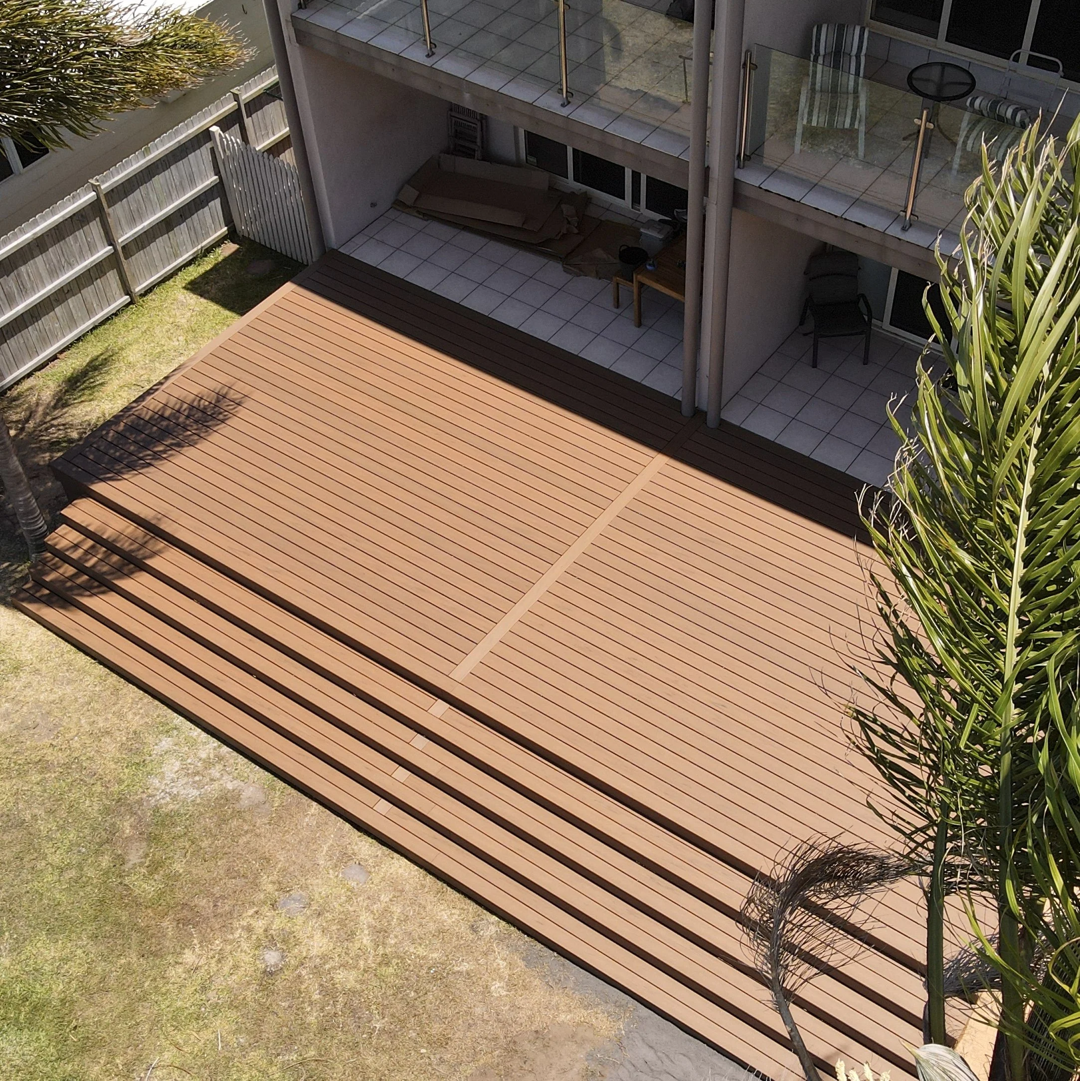 Trex deck in Jasper and landscaped greenery completed by Platinum Decks to showcase a luxury blend of textures and outdoor comfort