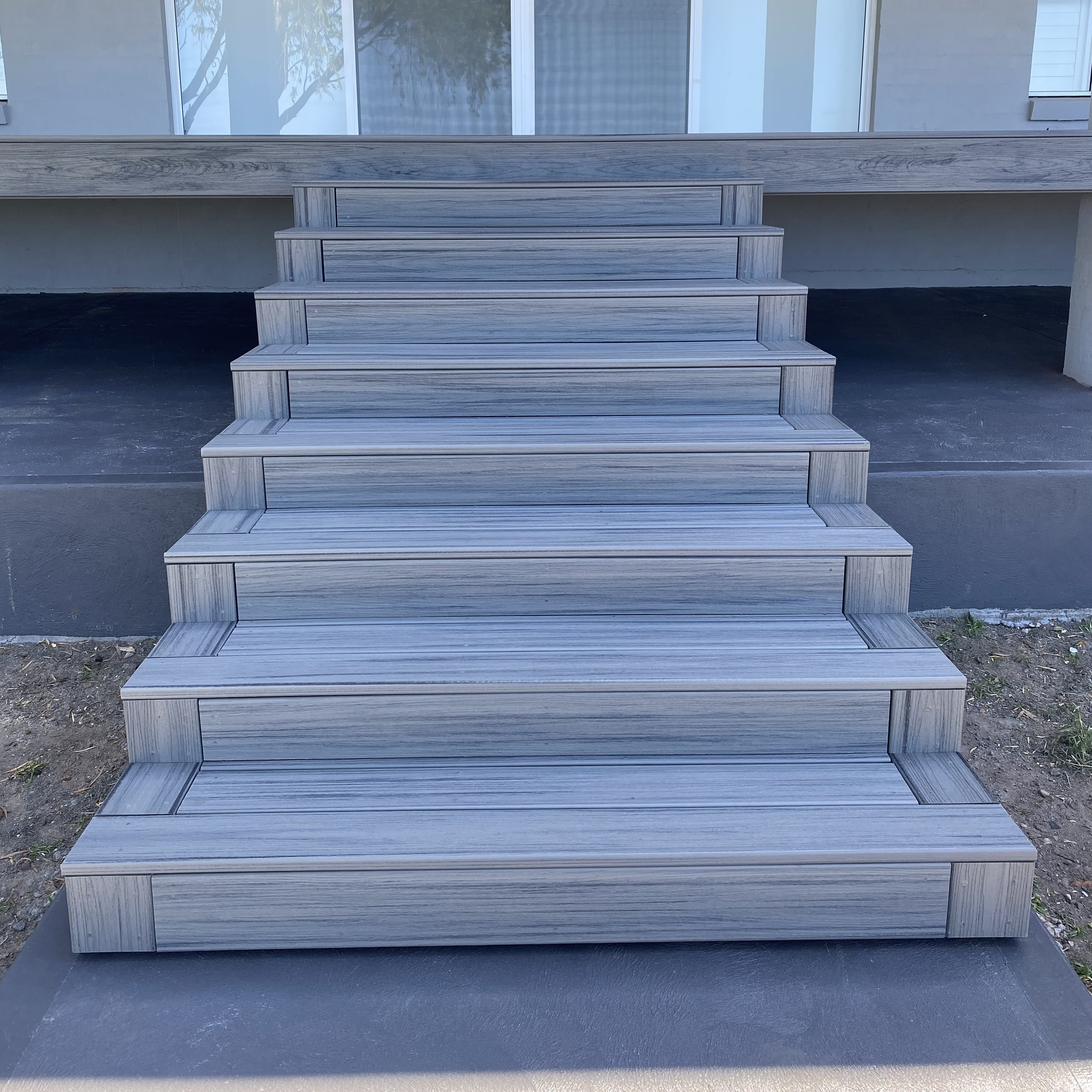 Custom composite staircase with clean, uniform treads built by Platinum Decks to provide a luxury entry point that performs in coastal conditions