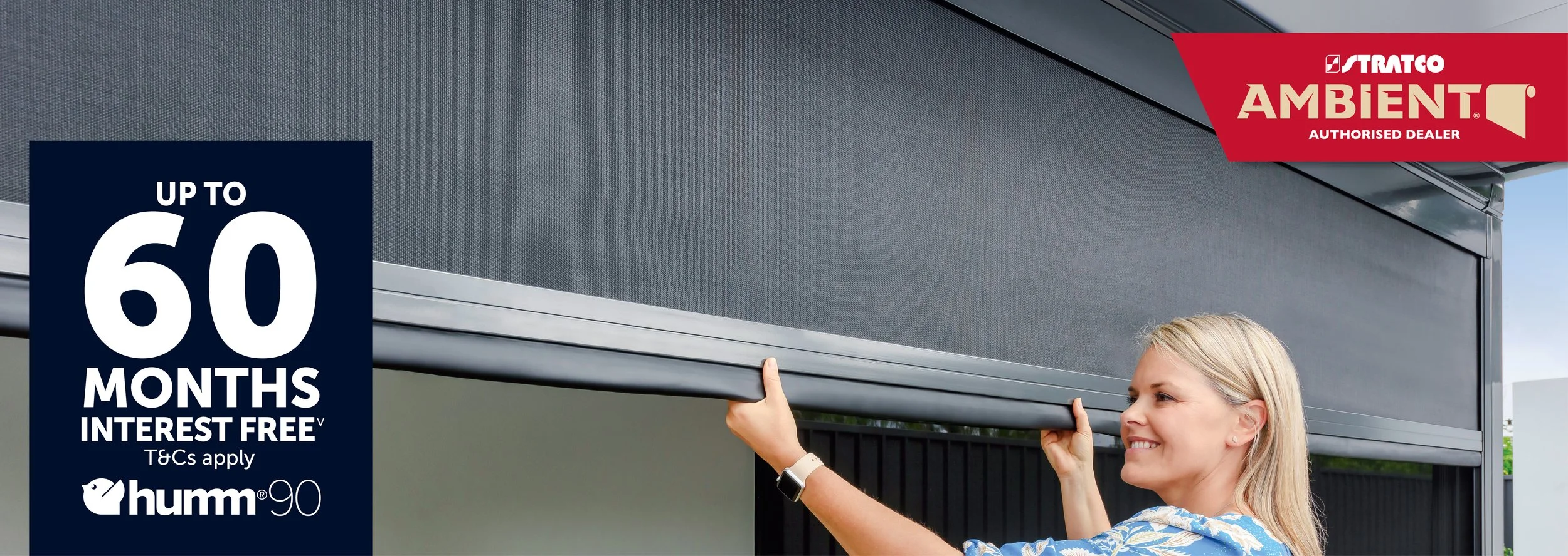 A woman installing an outdoor roller shutter. marketing text on the image includes a promotion for up to 60 months interest free financing from humm and tags indicating it's an authorized dealer for Stratco Ambient.