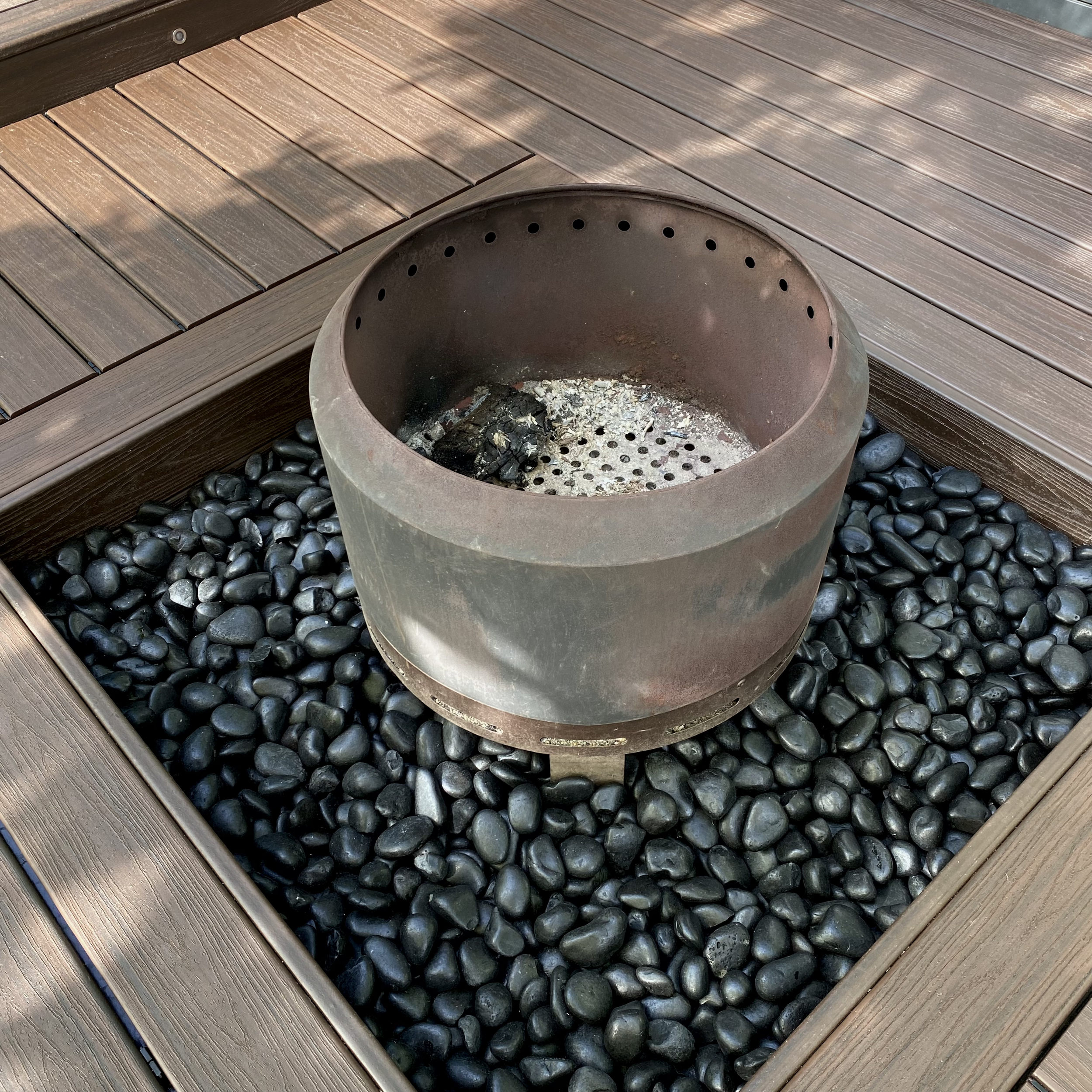 A bespoken fire pit with a large compsite deck surround built and designed by Platinum Deck on the NSW Central Coast.