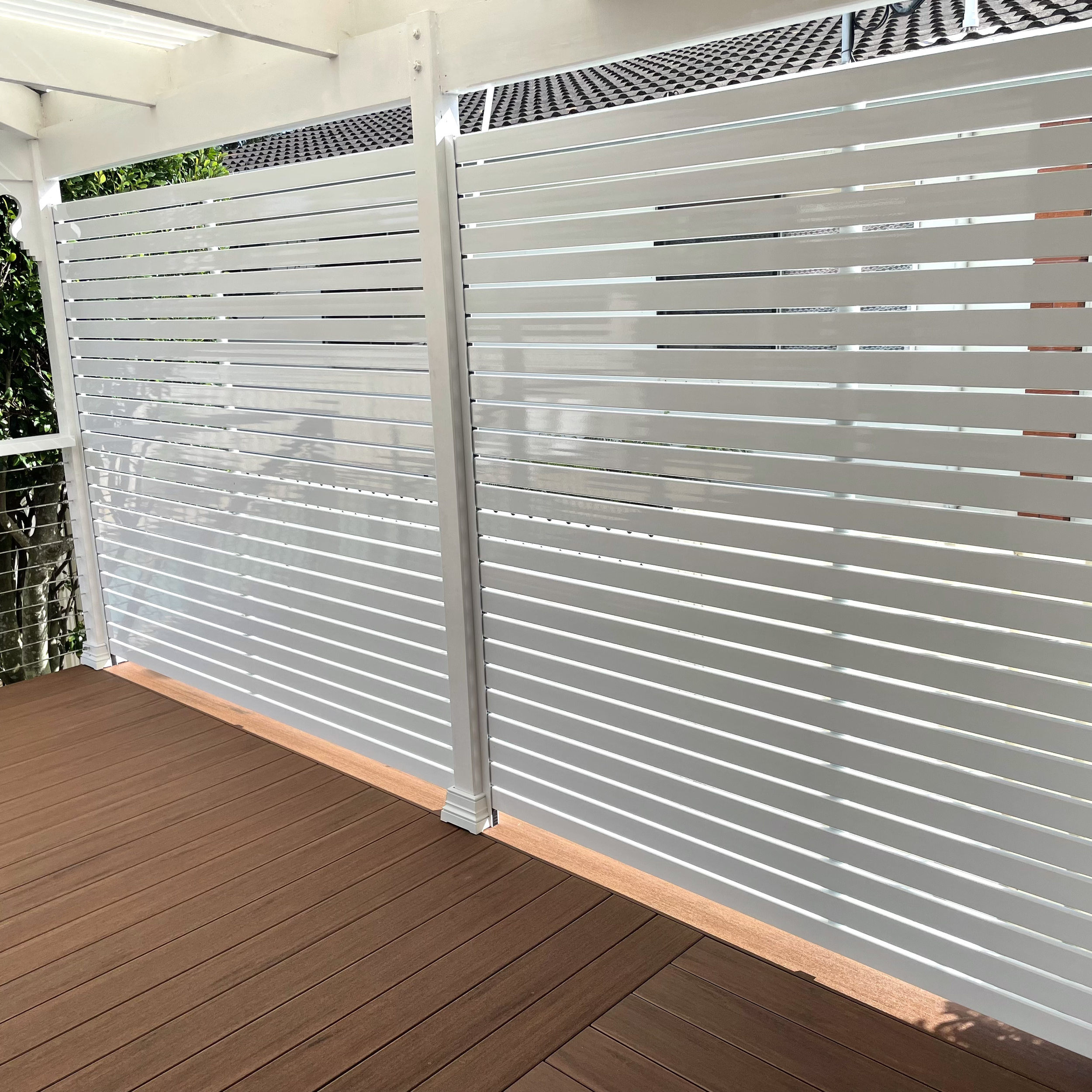 Custom slatted privacy screen crafted for premium outdoor living designed by Platinum Decks to bring a refined architectural edge to coastal homes