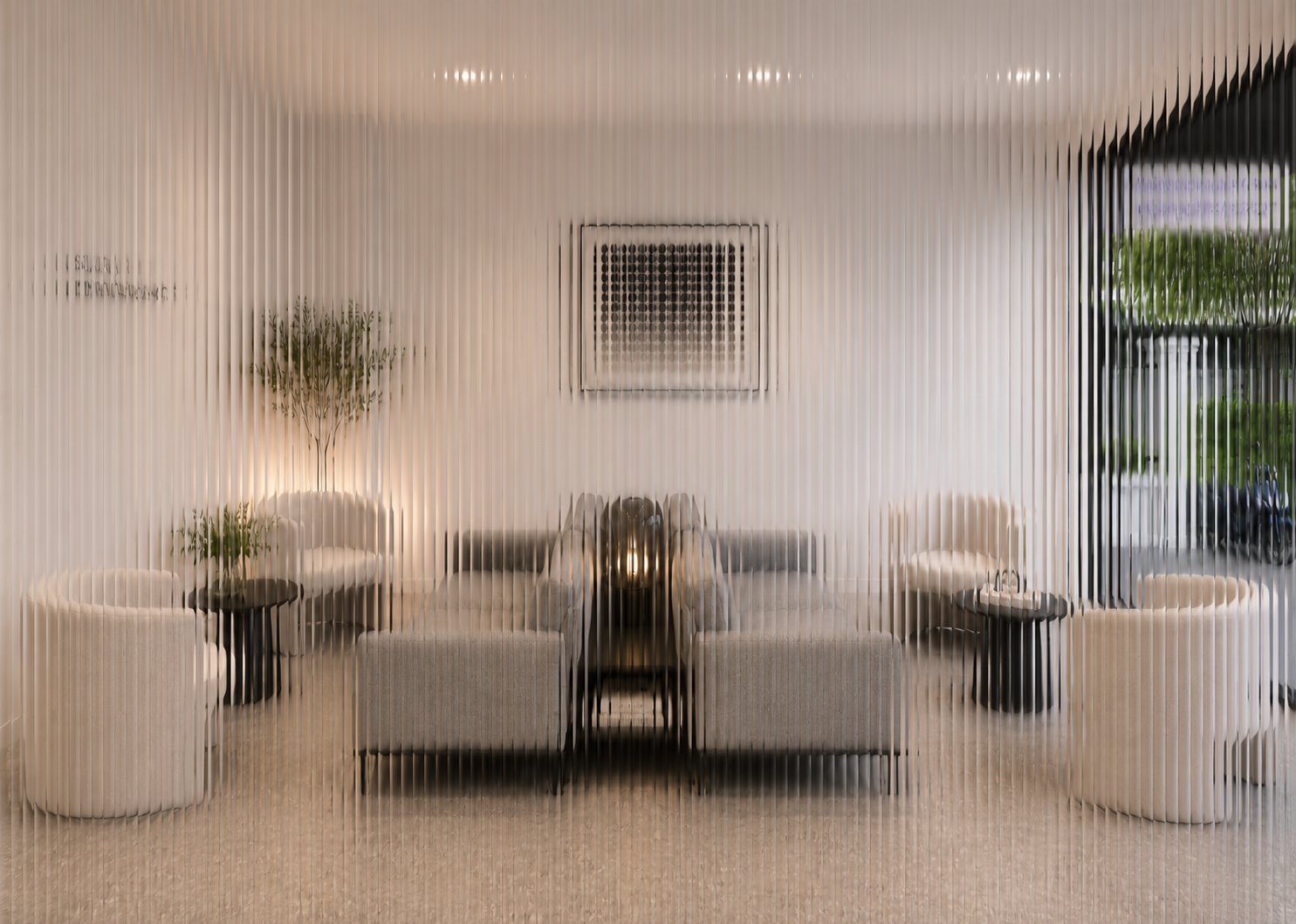 A waiting area with six white armchairs, two black side tables with plants, a central sofa, a framed artwork, and a large window with green plants outside, viewed through a frosted glass panel.