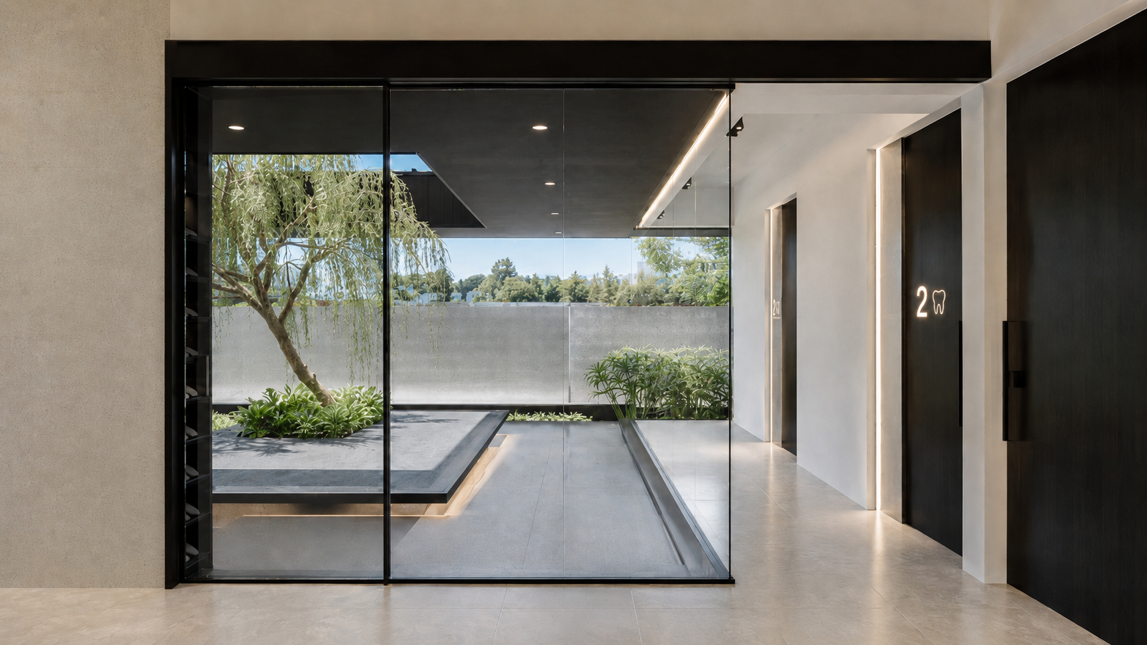 Modern hallway with glass wall, elevator doors marked '2' with a tooth icon, and indoor garden with trees and plants outside.