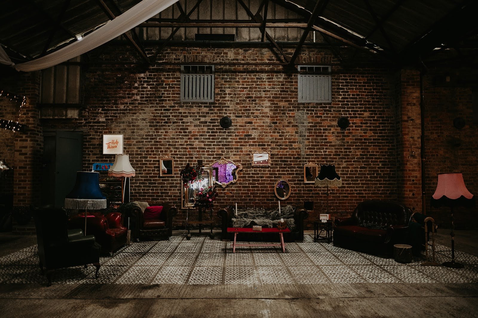 Industrial wedding venue styling featuring exposed brickwork, vintage furnishings and alternative wedding inspiration.