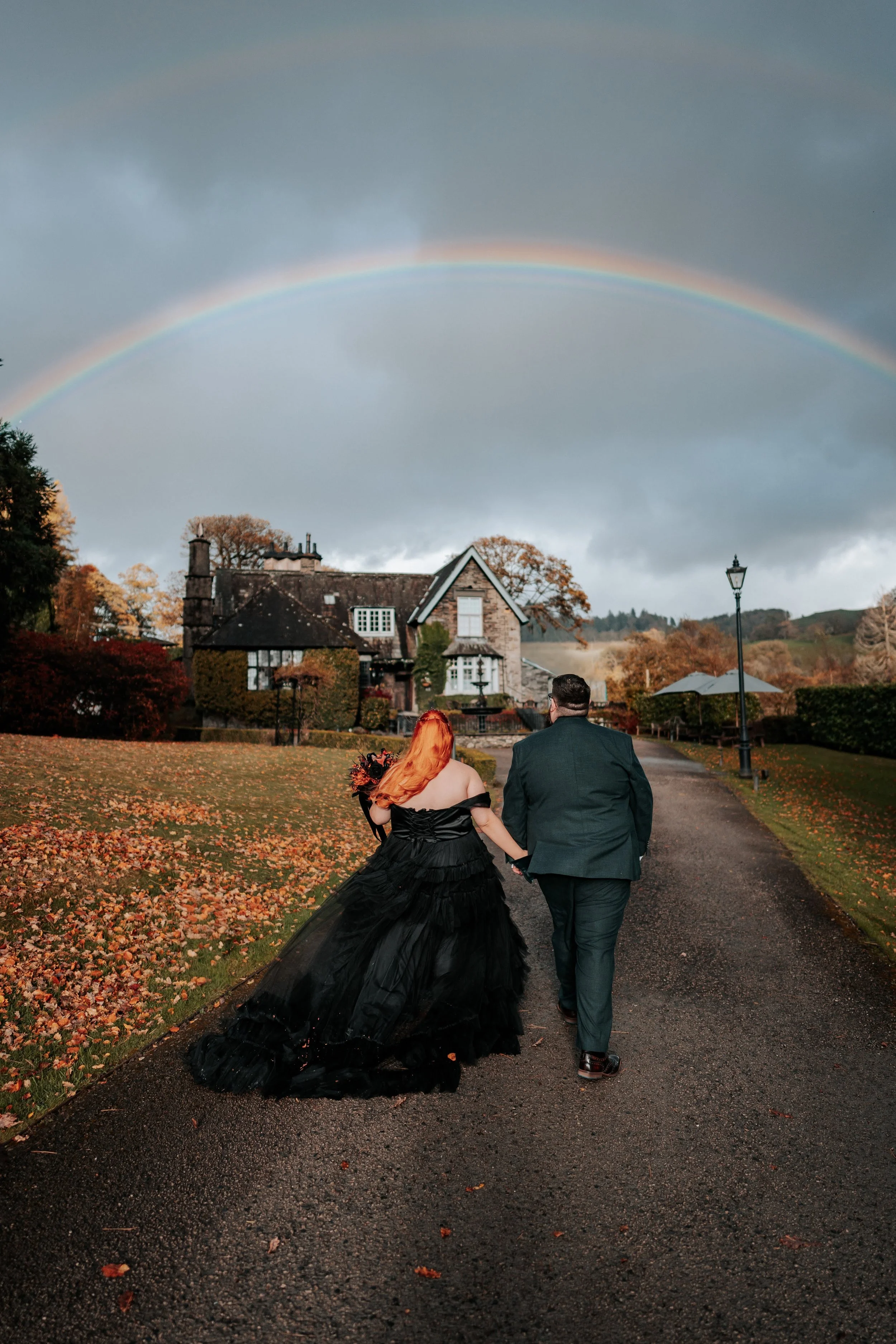 Alternative wedding couple enjoying an outdoor celebration surrounded by autumn colours and romantic wedding photography.