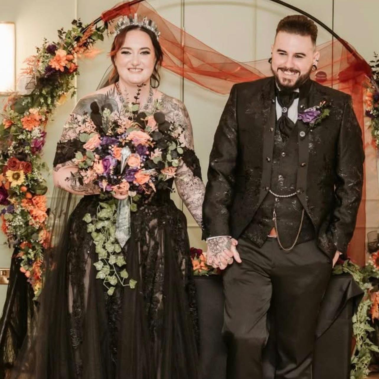 Alternative gothic wedding couple celebrating a darkly romantic wedding surrounded by dramatic florals.