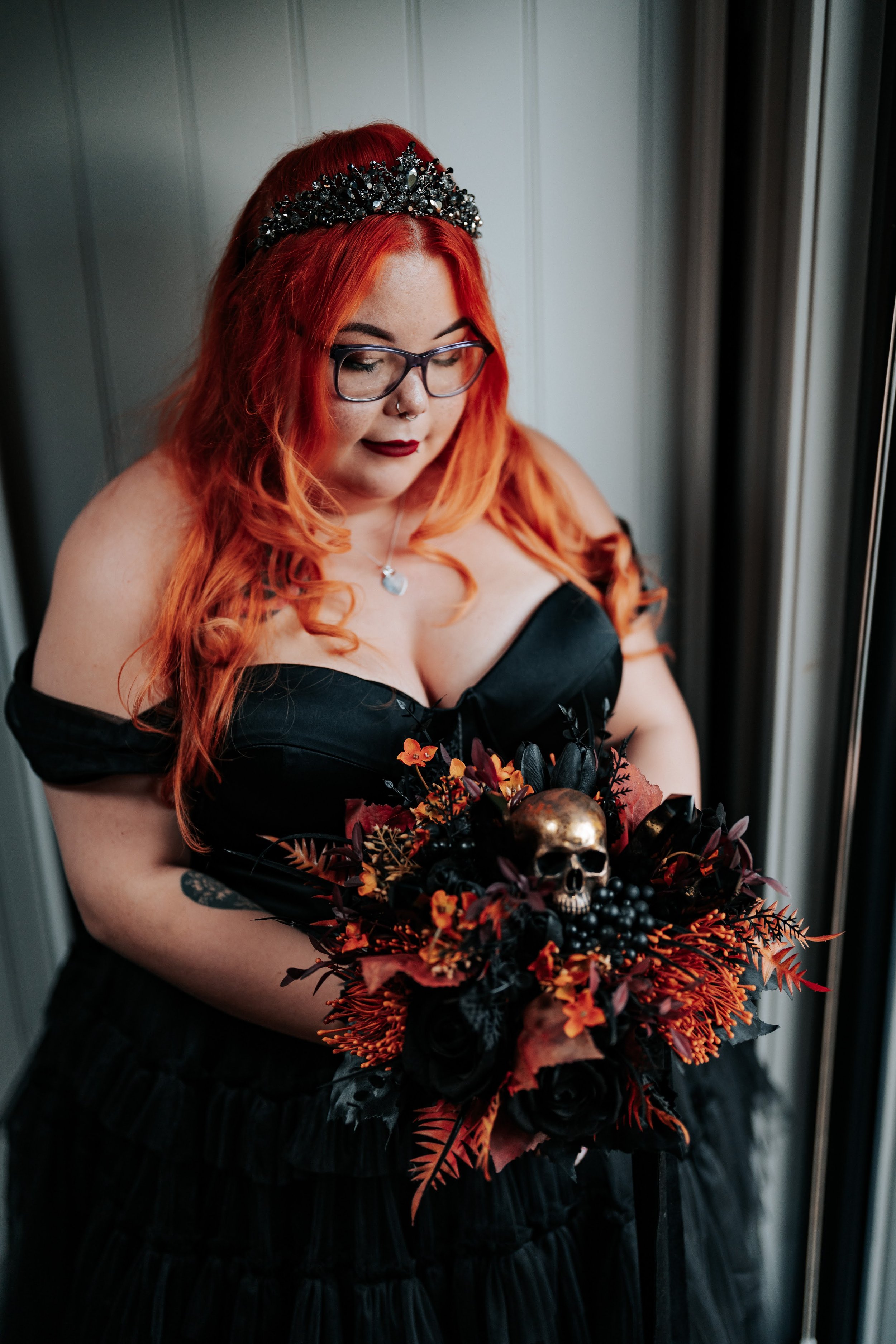 Gothic wedding bouquet featuring dark florals, skull details and alternative bridal styling.
