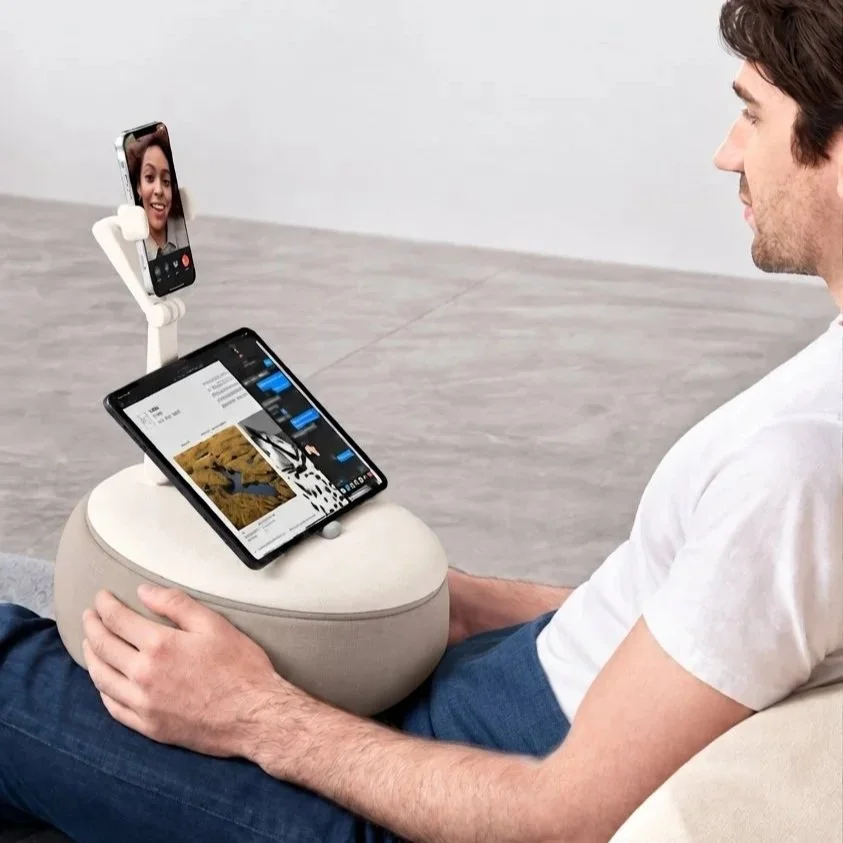 Person using the ALYVI V2 cushioned stand on their lap for comfortable hands-free screen viewing.