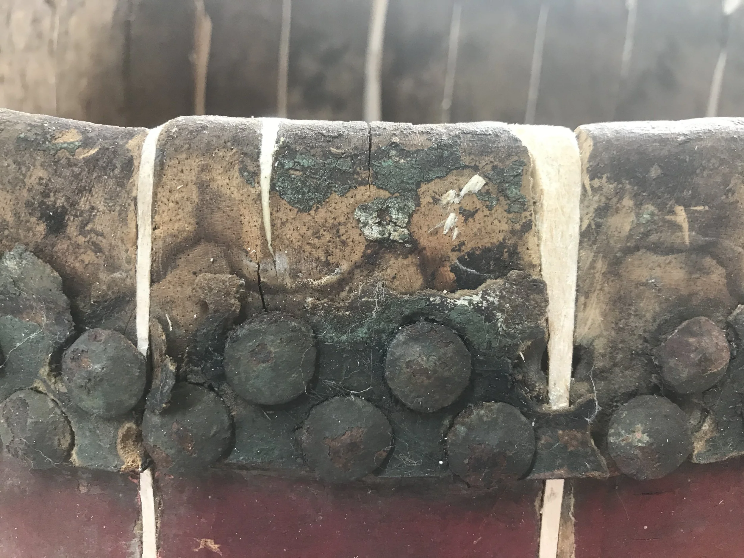 Close-up of a stack of the top of an aged chinese ceremonial drum where timber fillets have been cut to fill gaps and losses.