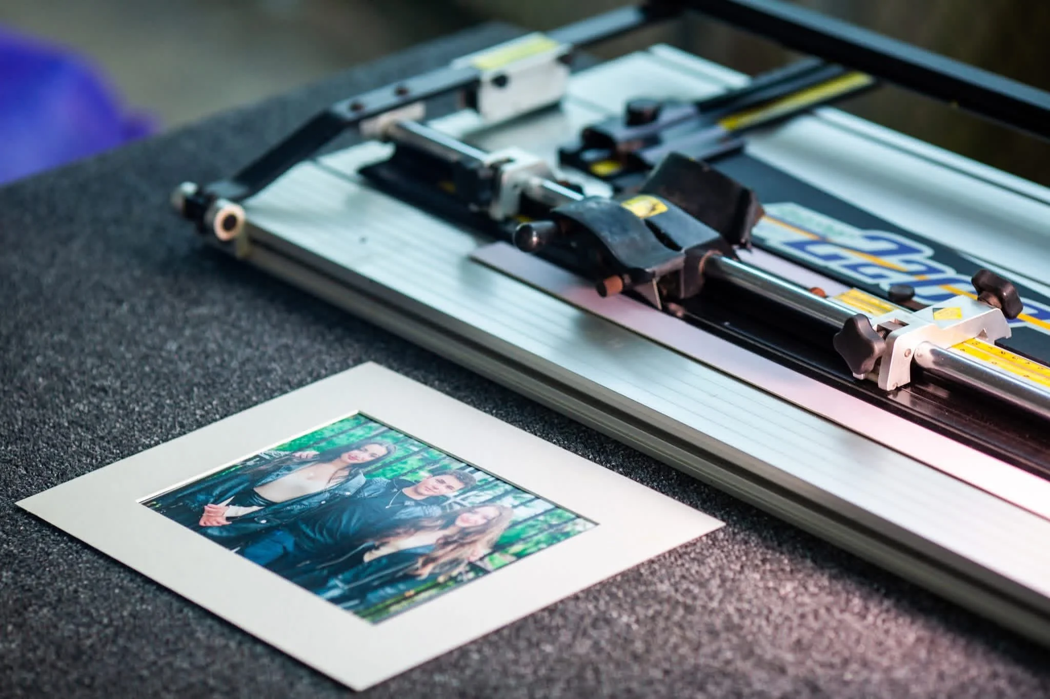 Printing machine printing photographs of women in leather jackets on photo paper